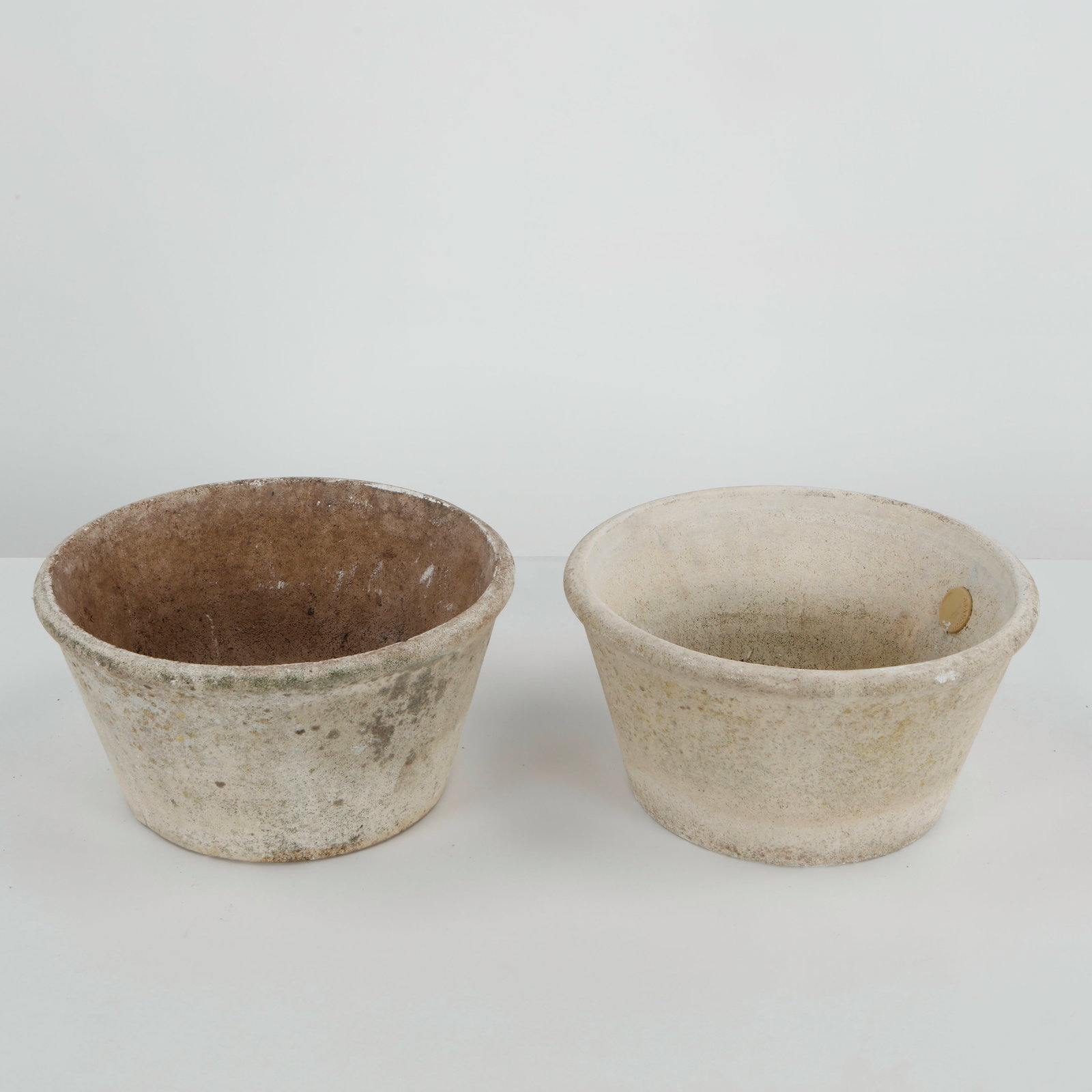 Grandon Fres, Pair of Concrete Round Planters, 1960s: A pair of hand-cast concrete planters by Grandon Fres, featuring a clean, tapered silhouette with a beautifully weathered surface. Elegant examples of French garden design, ideal for both indoor and o