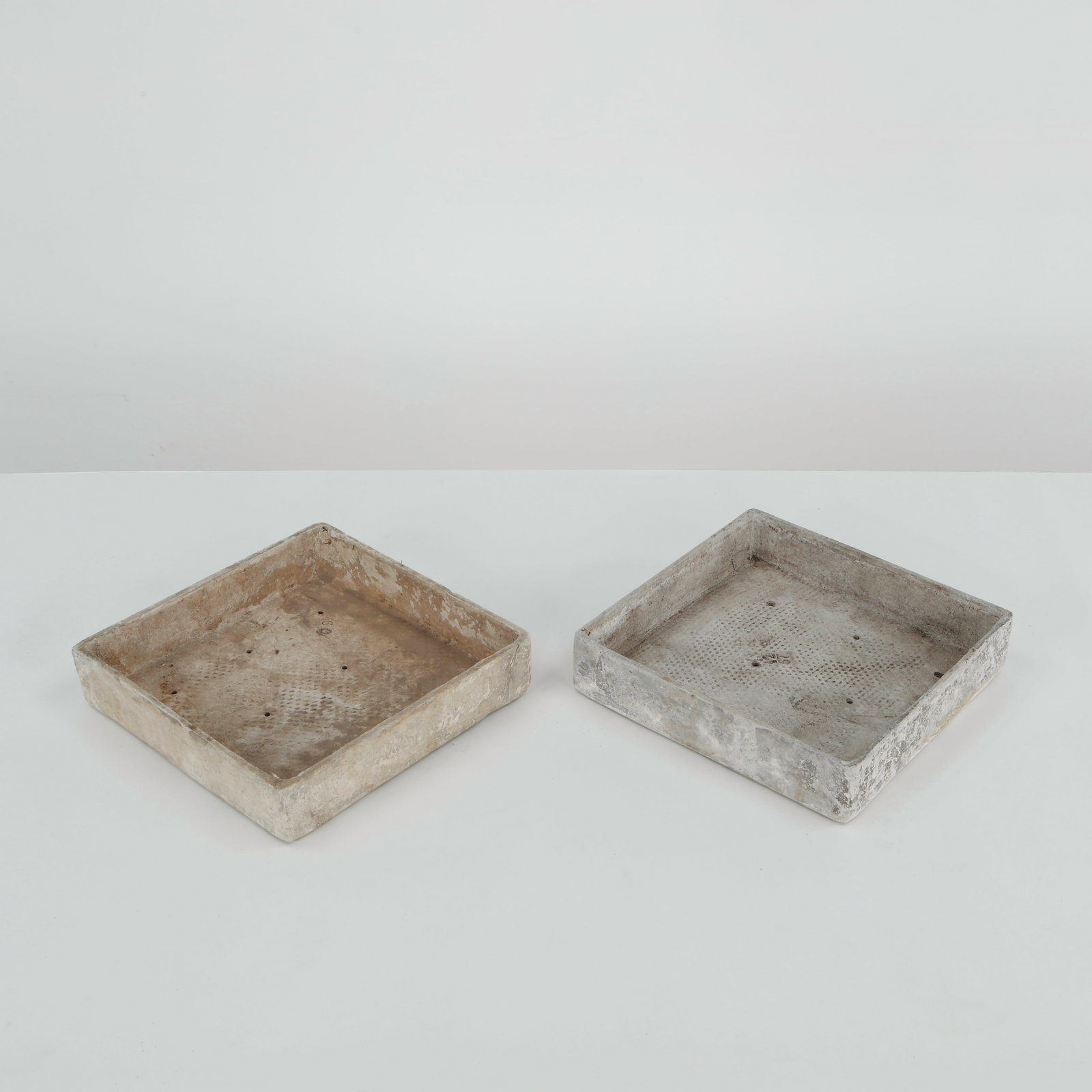 Willy Guhl, Pair of Square Tray Planters, 1960s: Rare pair of square Eternit tray planters designed by Willy Guhl, executed in fiber cement with clean geometric proportions and softened edges. Their restrained architectural form and naturally weathe