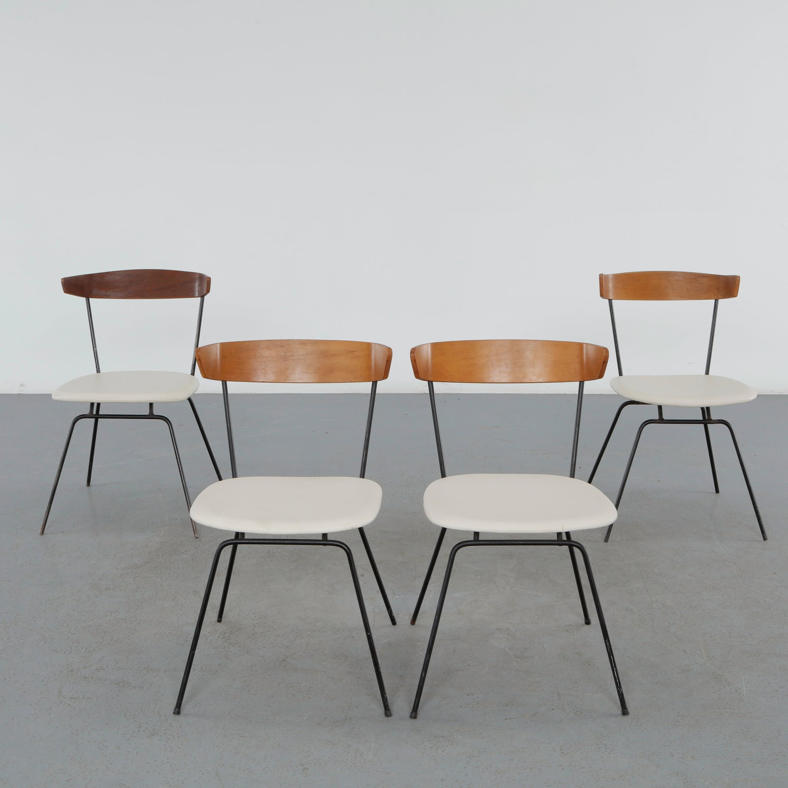 Clifford Pascoe, Set of Four Dining Chairs, 1960s: Set of four dining chairs attributed to Clifford Pascoe, combining sculptural walnut backrests with slender metal frames. A refined example of American mid-century design balancing warmth and function