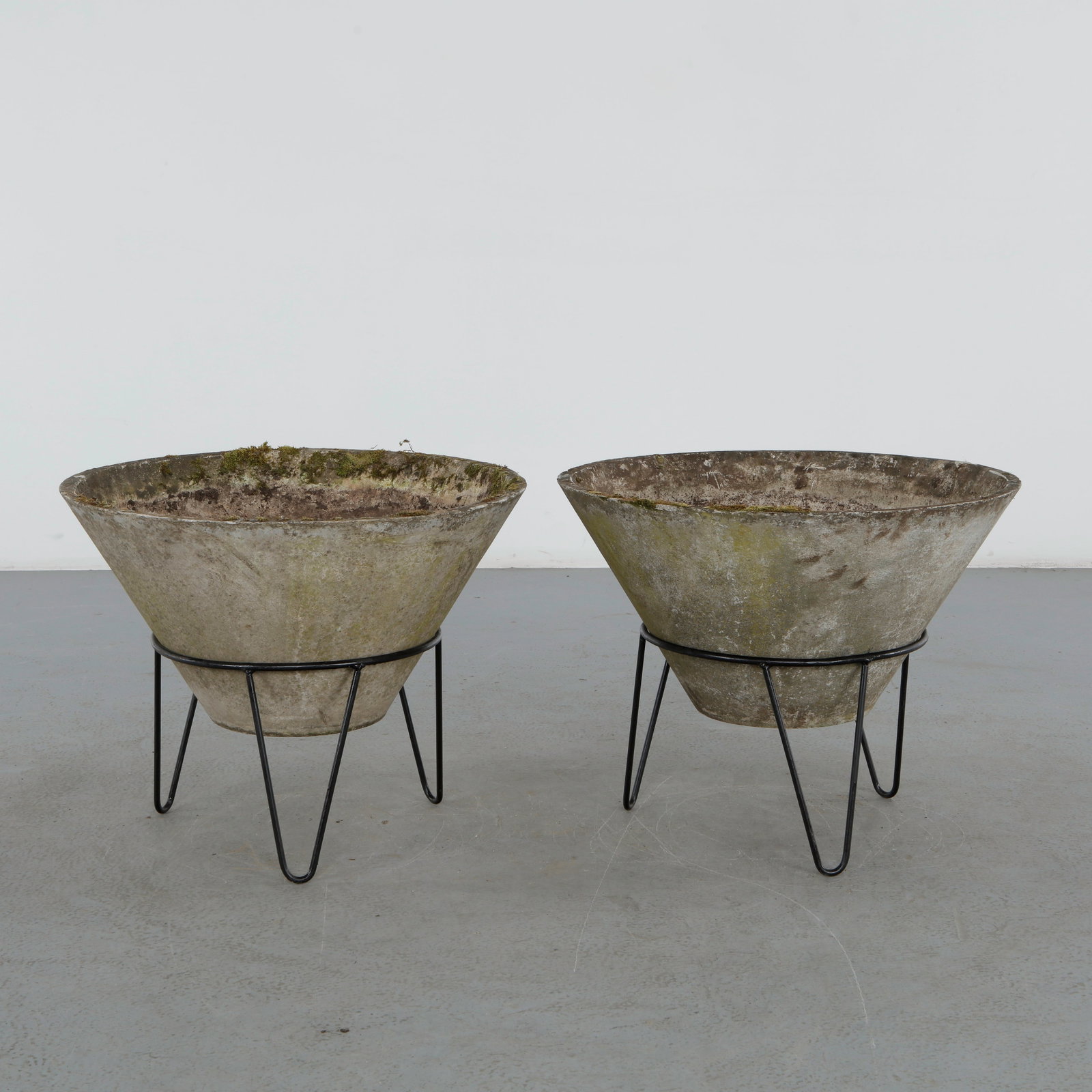 Willy Guhl, Pair of Large Conical Planters on Stands, 1960s: Iconic Willy Guhl silhouettes in Large form, these conical planters rest atop minimalistic metal stands, weathered yet timeless. Height: 22.5 in. Diameter: 28 in.
