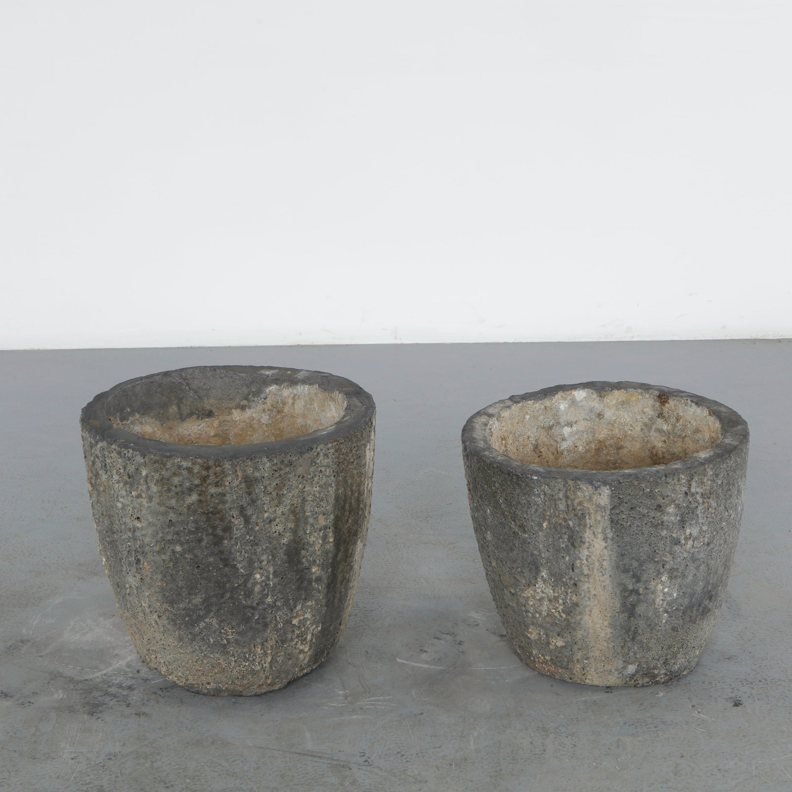 Pair of Small Foundry Crucible Planters, 1960s: A pair of small vintage foundry crucible planters, their compact tapered bodies in rough cast refractory material bearing a naturally weathered, fire-marked surface.