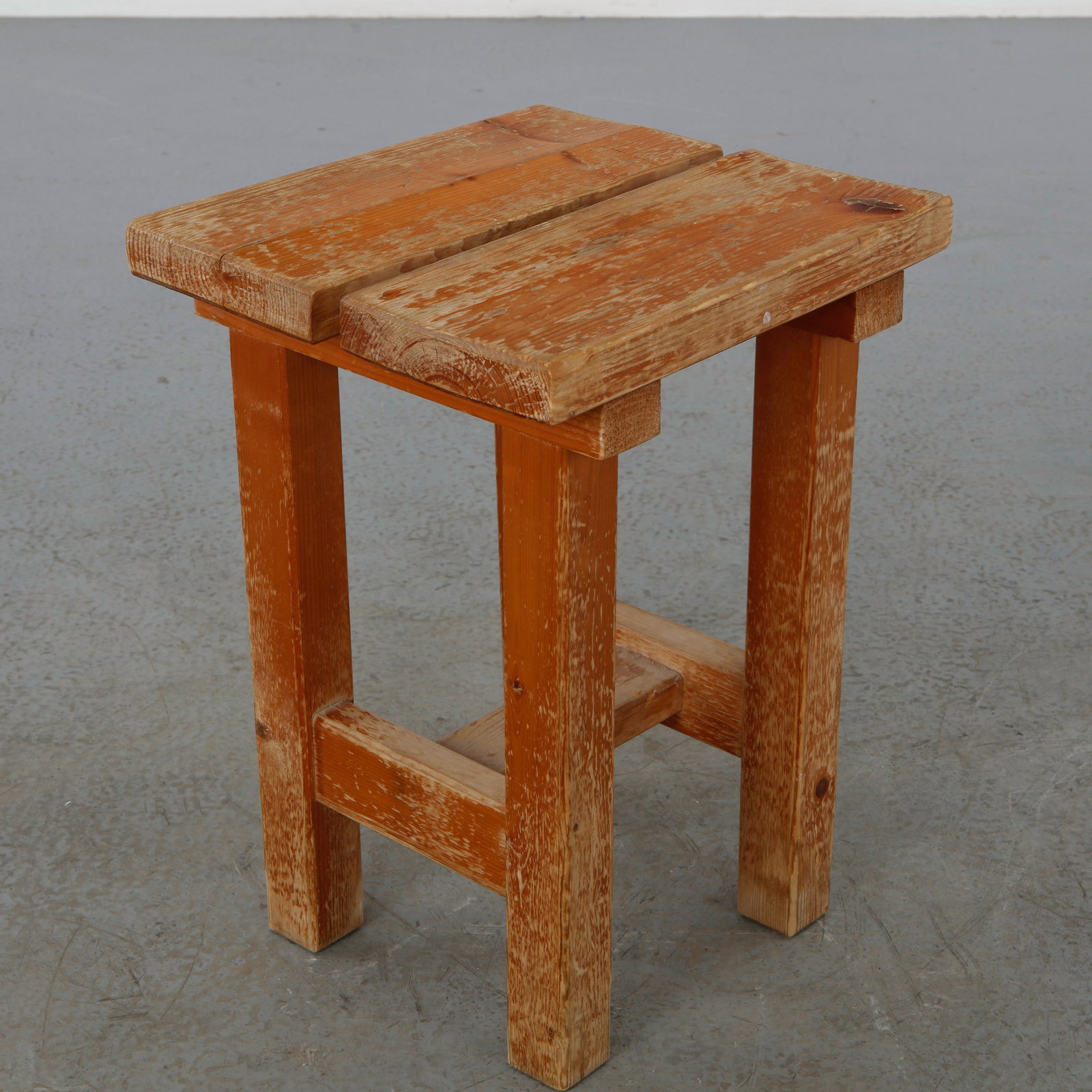 Pine Stool in the style of Charlotte Perriand, 1960s: Crafted in solid pine, this square stool embodies the honest construction and understated rustic character associated with Charlotte Perriand mountain furniture. A timeless and versatile design with a