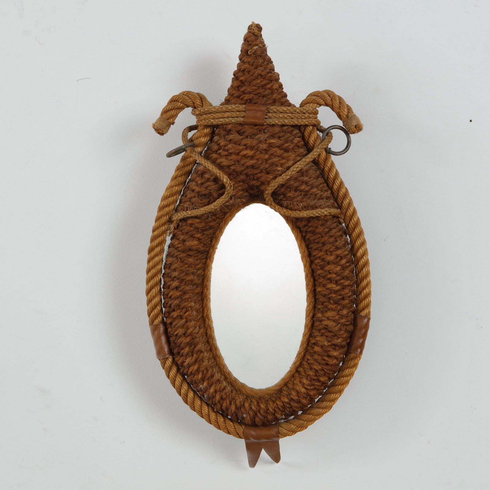 Audoux Minet, Rope Mirror, 1960s: A refined example of Audoux Minet celebrated use of rope craftsmanship, featuring an oval mirror enclosed within a hand wrapped rope frame. The organic materials and artisanal execution exemplify the