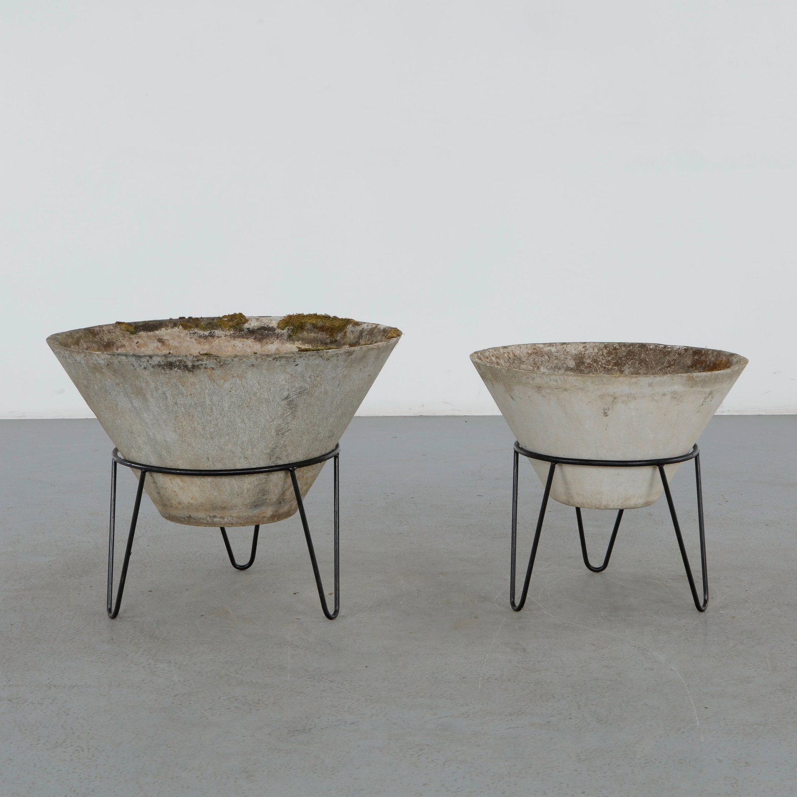 Willy Guhl, Pair of Medium and Large Conical Planters on Stands, 1960s: Iconic Willy Guhl silhouettes, these conical planters rest atop minimalistic metal stands, weathered yet timeless. Height: 22 in. Diameter: 28 in. Medium: Height: 20 in. Diameter: 22 in.