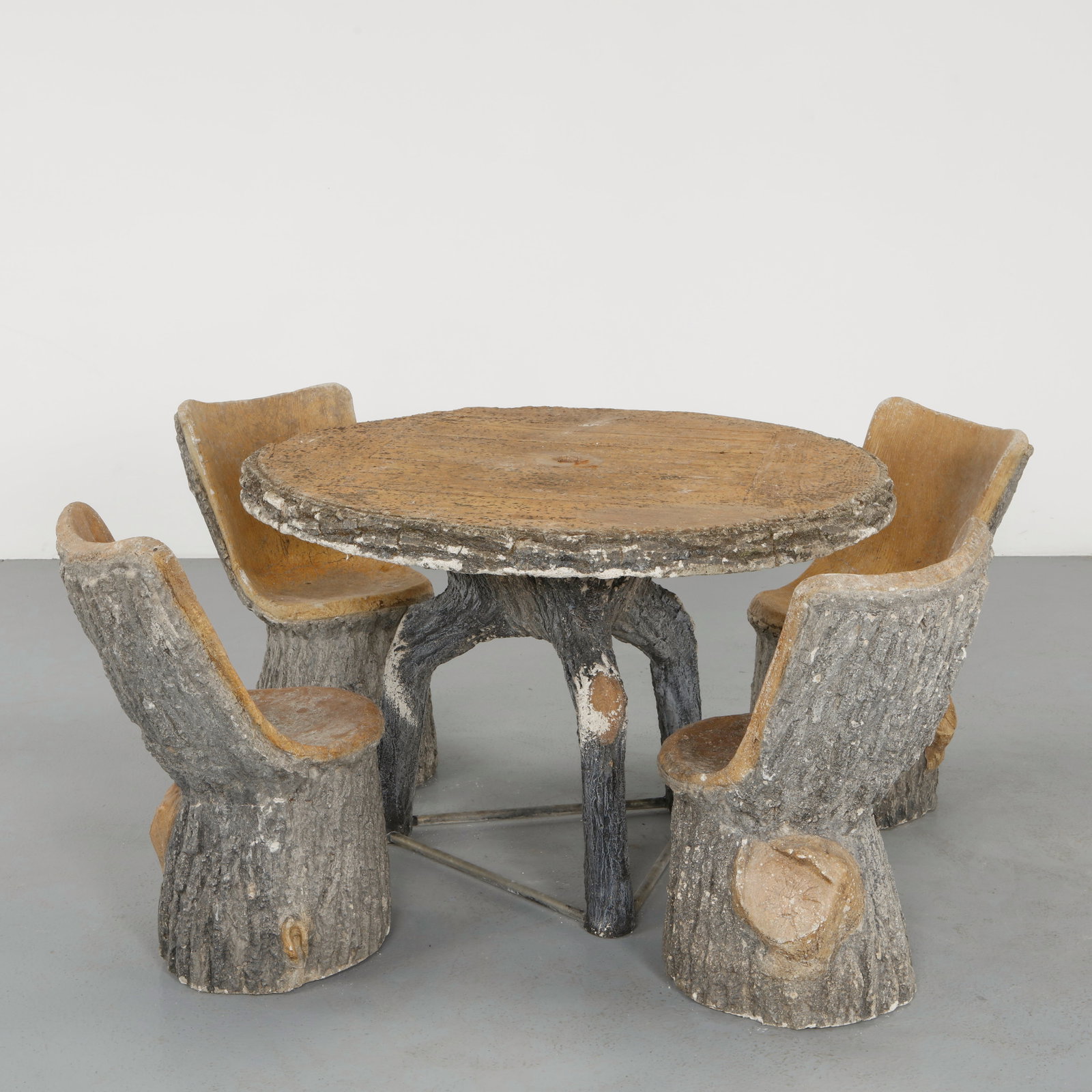 Lind Lenz, Faux Bois Dining Set, 1960s: A stunning and extremely rare outdoor dining ensemble executed in sculptural concrete, featuring a circular table supported by branching legs and four armchairs carved in a trunk-like form. The
