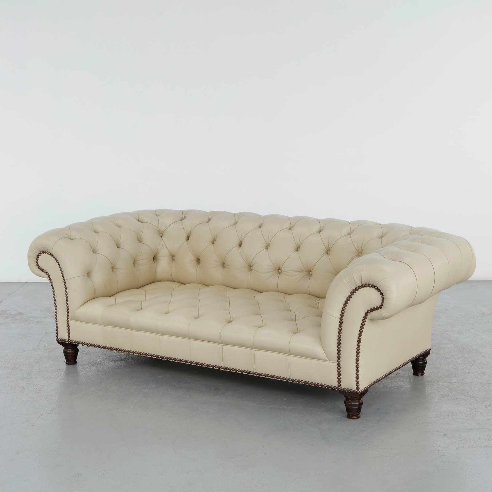 George Smith, Jules Sofa Chesterfield Style: Crafted in hand-tufted cream leather, this George Smith Jules sofa reinterprets the timeless Chesterfield silhouette with generous proportions and refined English craftsmanship. Finished with hand-app