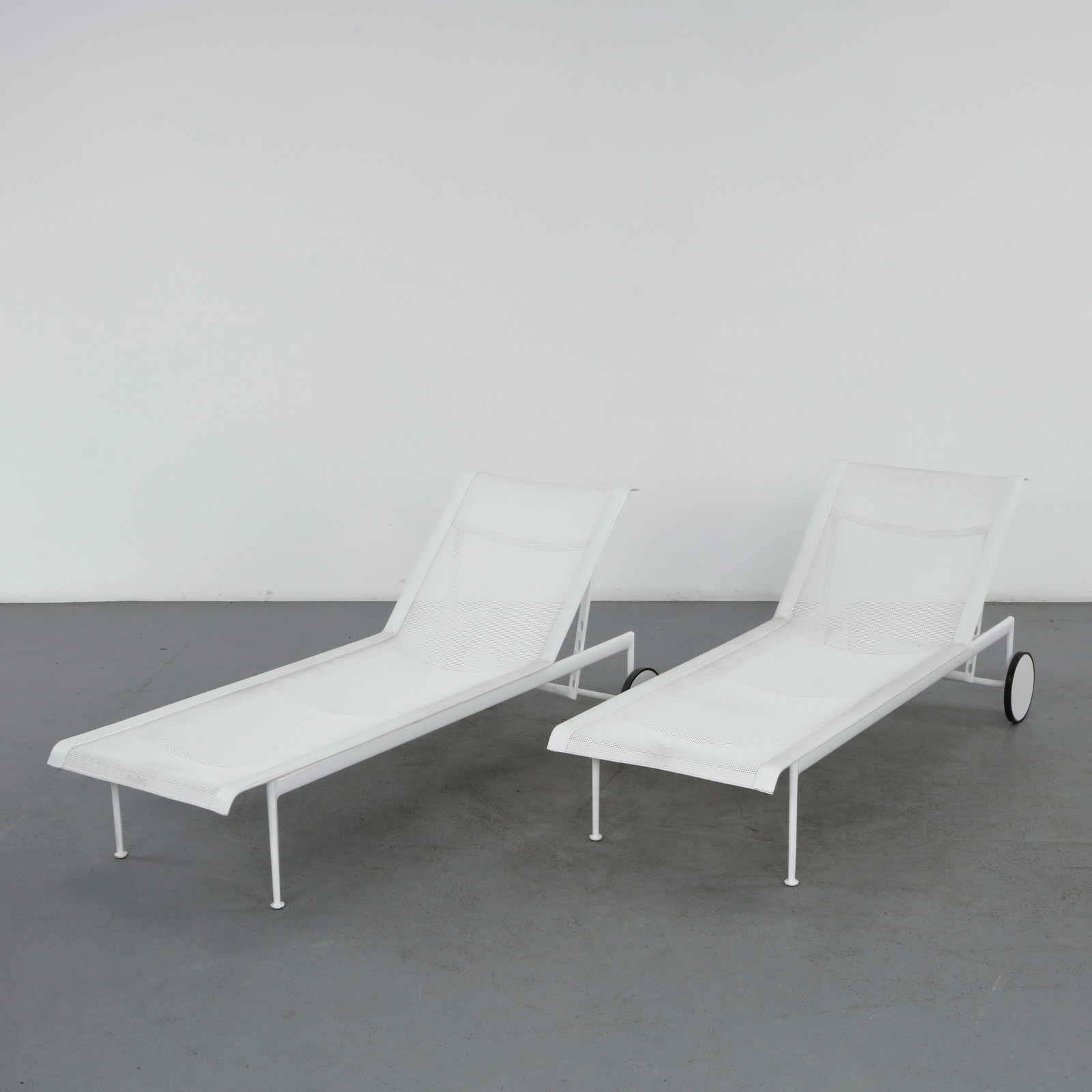Richard Schultz for Knoll, Pair of 1966 Collection Outdoor Adjustable Chaises: A pair of adjustable chaise lounges in white powder-coated aluminum with taut white mesh slings, each fitted with rear wheels for easy mobility.Height: 14 in. Height Back Rest up: 35.5 in. Length: 77 
