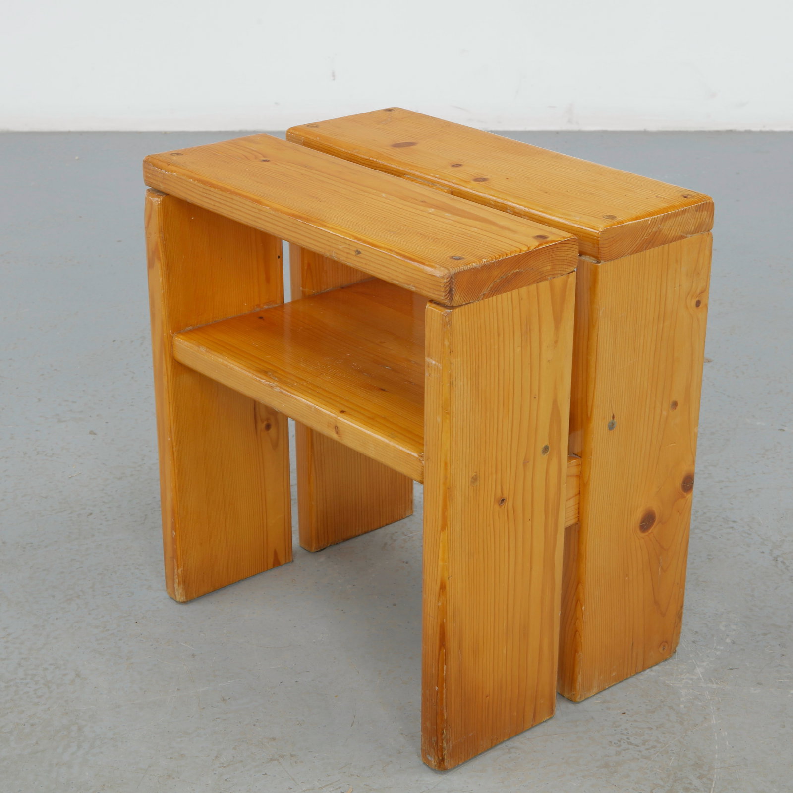 Charlotte Perriand for Les Arcs 1600, Pine Stool, 1960s: A solid pine two tier stool with a slatted upper seat and lower shelf. Pale, warm grain and visible joinery, doubling as a low occasional table.