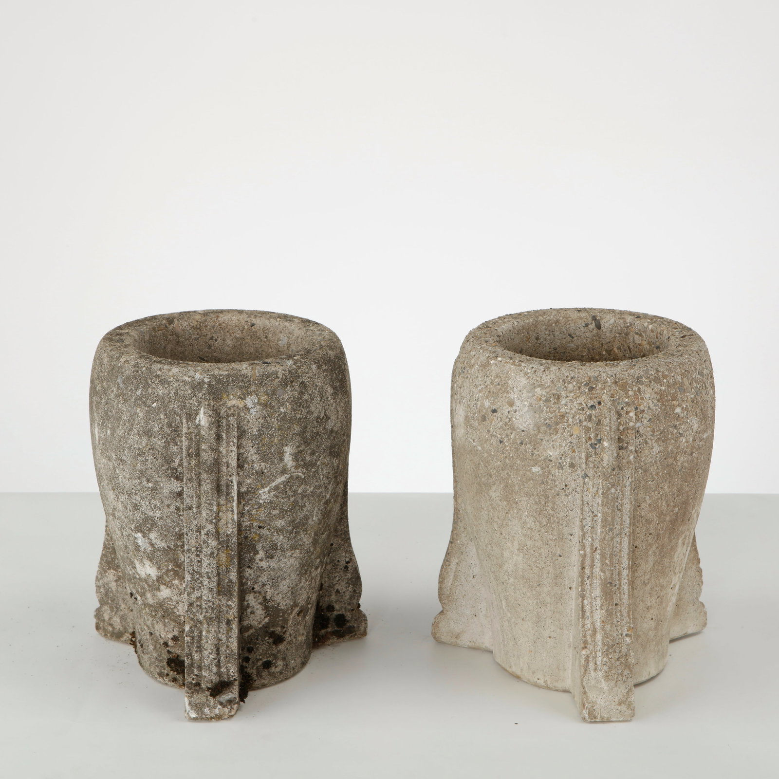 Pair of Tripod Stone Planters, 1950s: Pair of small stone planters raised on three integrated feet, featuring a compact sculptural form and deeply textured, timeworn surfaces. Height: 11 in. Diameter: 8 in. Opening Diameter: 6 in.