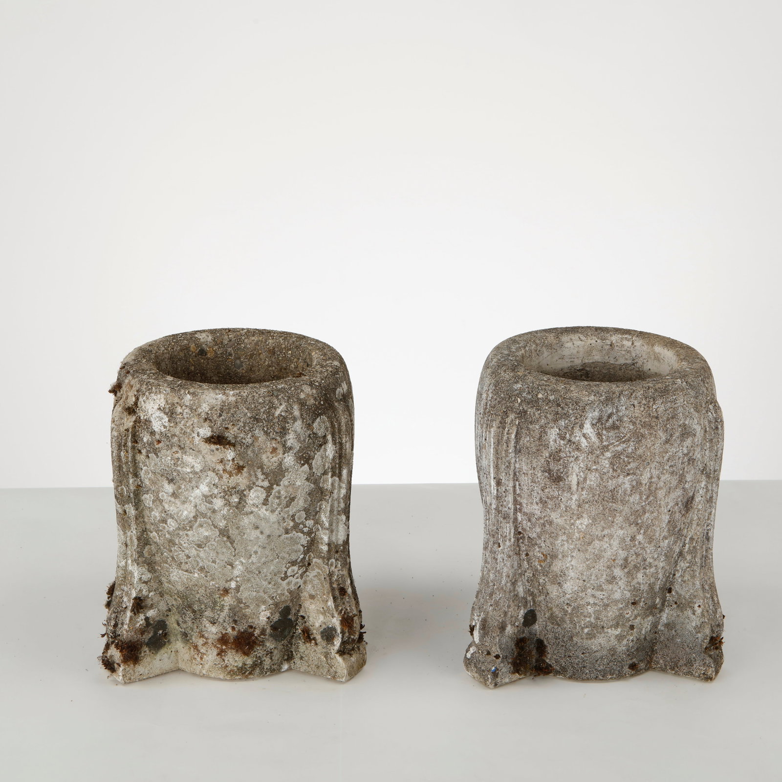 Pair of Tripod Stone Planters, 1950s: Pair of small stone planters raised on three integrated feet, featuring a compact sculptural form and deeply textured, timeworn surfaces. Height: 11 in. Diameter: 8 in. Opening Diameter: 6 in.