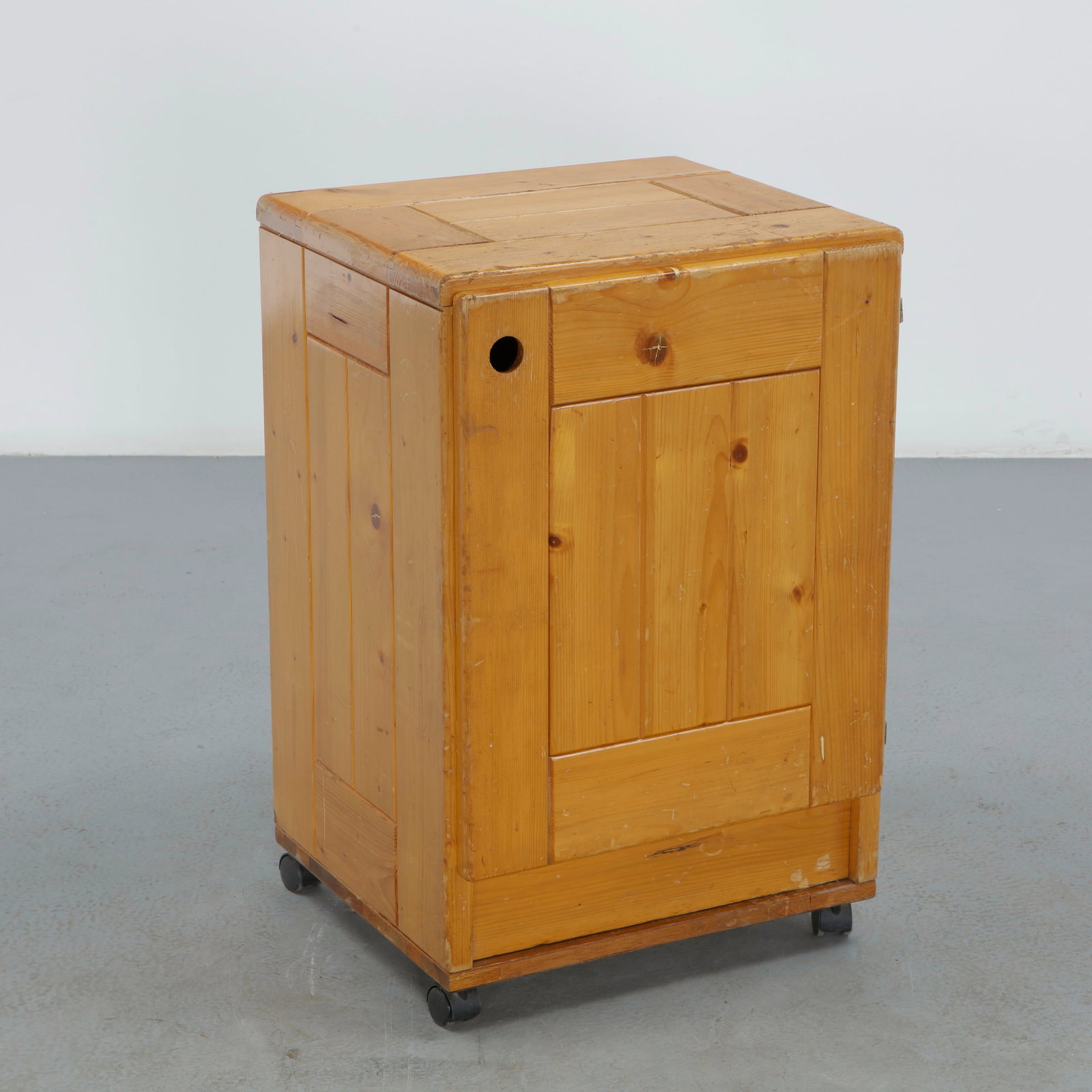 Charlotte Perriand for Les Arcs 1600, Pine Cabinet on Wheels, 1960s: A mobile pine cabinet designed by Charlotte Perriand for the Les Arcs 1600 ski resort, with a plank top, a single drawer, and a door below, the whole raised on casters for easy movement, practical, mi