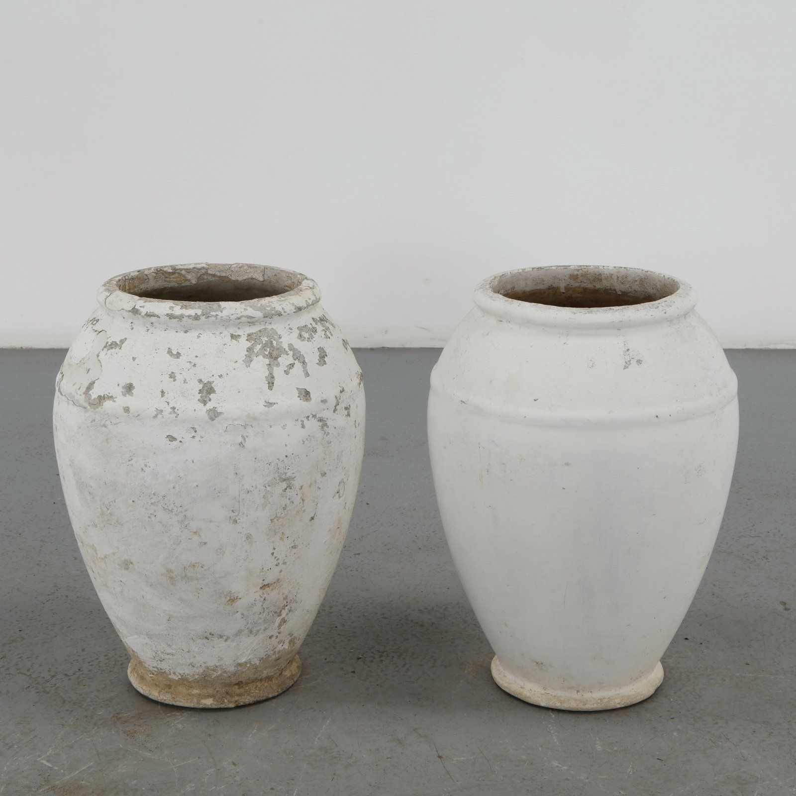 Willy Guhl, Pair of Urn Planters, 1960s: A sculptural pair of Urn planters by Willy Guhl. Crafted in fiber cement for Eternit, Switzerland. Height: 20.5 in Opening Diameter: 8.75 in. Body Diameter: 14 in.