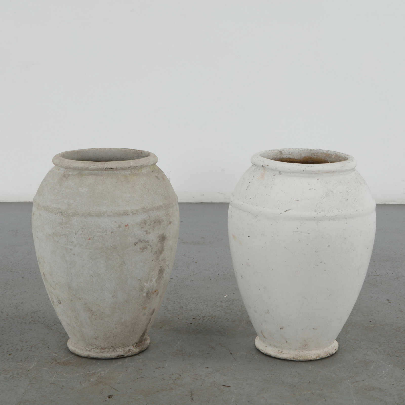 Willy Guhl, Pair of Urn Planters, 1960s: A sculptural pair of Urn planters by Willy Guhl. Crafted in fiber cement for Eternit, Switzerland. Height: 20.5 in Opening Diameter: 8.75 in. Body Diameter: 14 in.