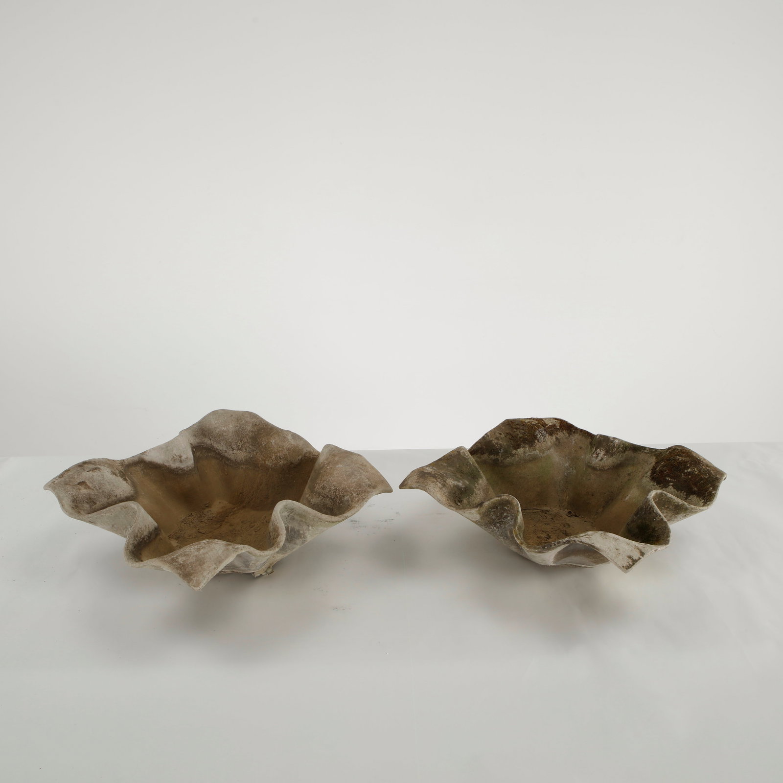Willy Guhl, Pair of Small Elephant Ear Planters, 1960s: Pair of small Elephant Ear planters, also known as handkerchief planters, by Willy Guhl for Eternit, Switzerland circa 1960. Factory-drilled drainage holes. Wonderful patina. Width: 20 in. Length: 20 