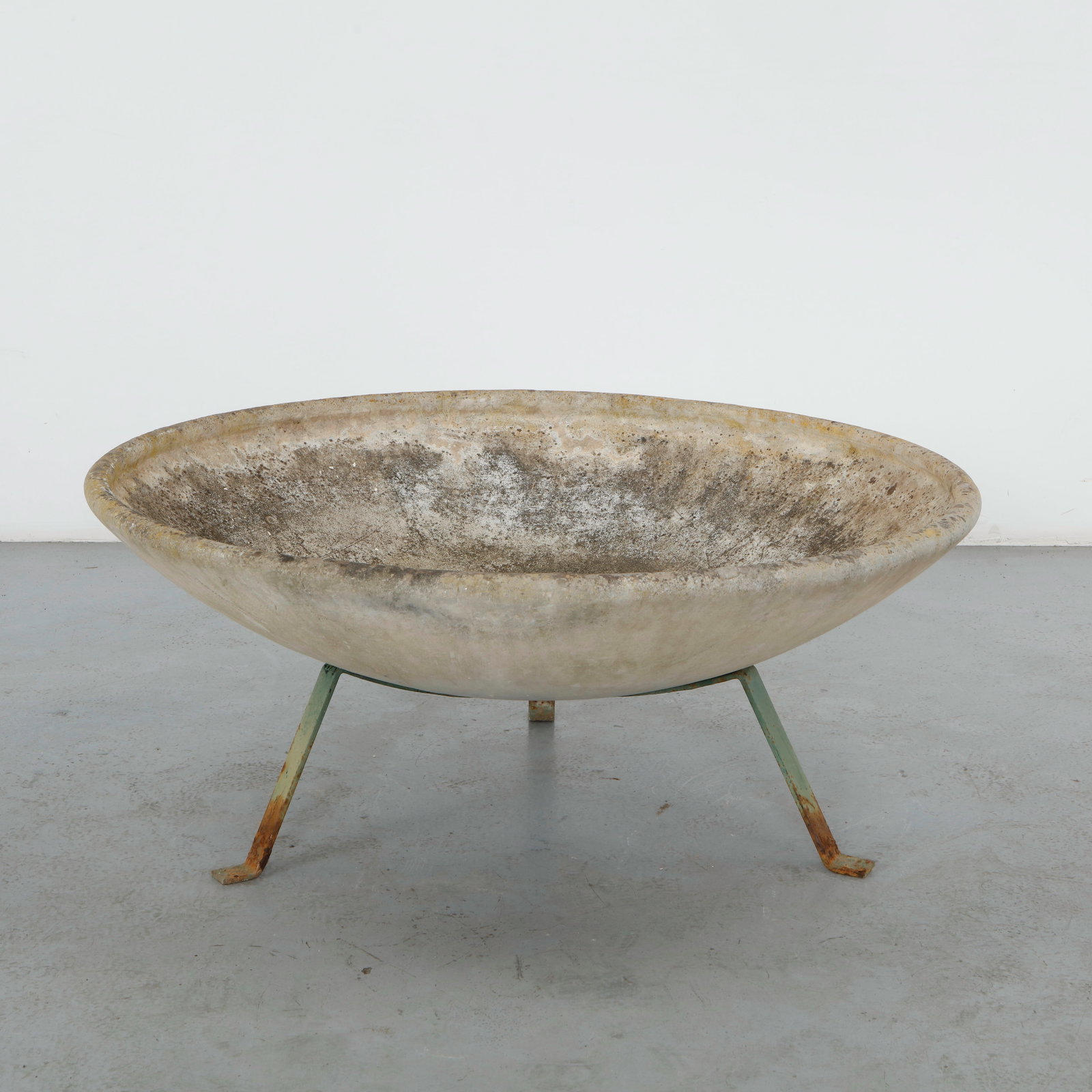Willy Guhl, Large Bowl Planter on Metal Stand, 1960s: A wide, shallow bowl planter in fiber cement, raised on its original slender three legged iron stand. Heavily weathered rim with rust staining to the stand, a sculptural example of Guhl functional gar