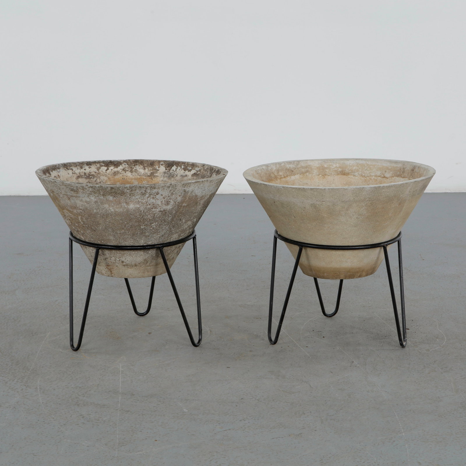 Willy Guhl, Pair of Conical Planters on Stands, 1960s: Iconic Willy Guhl silhouettes in compact form, these conical planters rest atop minimalistic metal stands, weathered yet timeless. Height: 20 in. Diameter: 22 in.