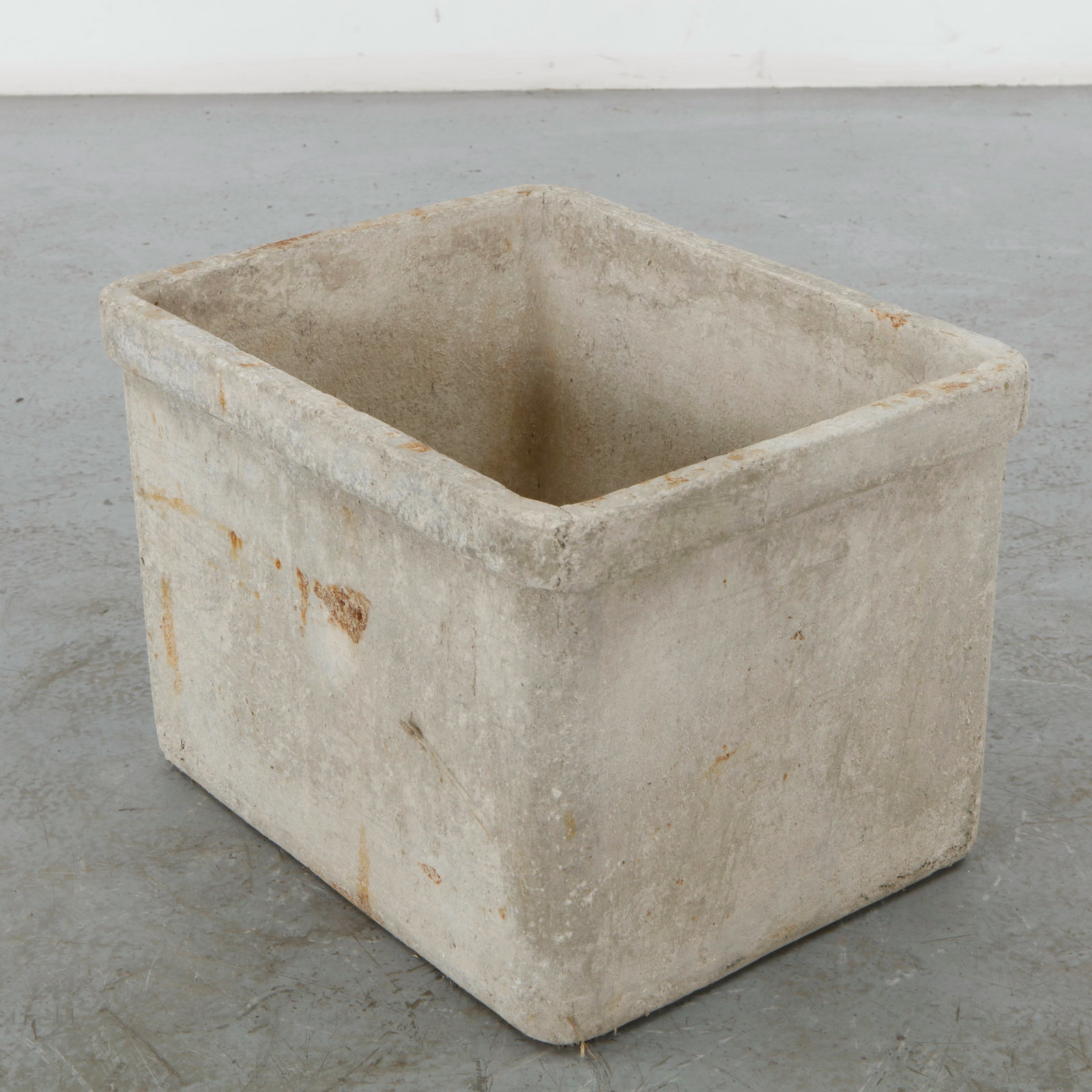 Willy Guhl, Rectangular Planter, 1960s: A rectangular planter in fiber cement, tapering to a straight rim. Cream grey surface with rust staining to one side. Height: 13.5 in. Length: 19 in. Width: 15 in.