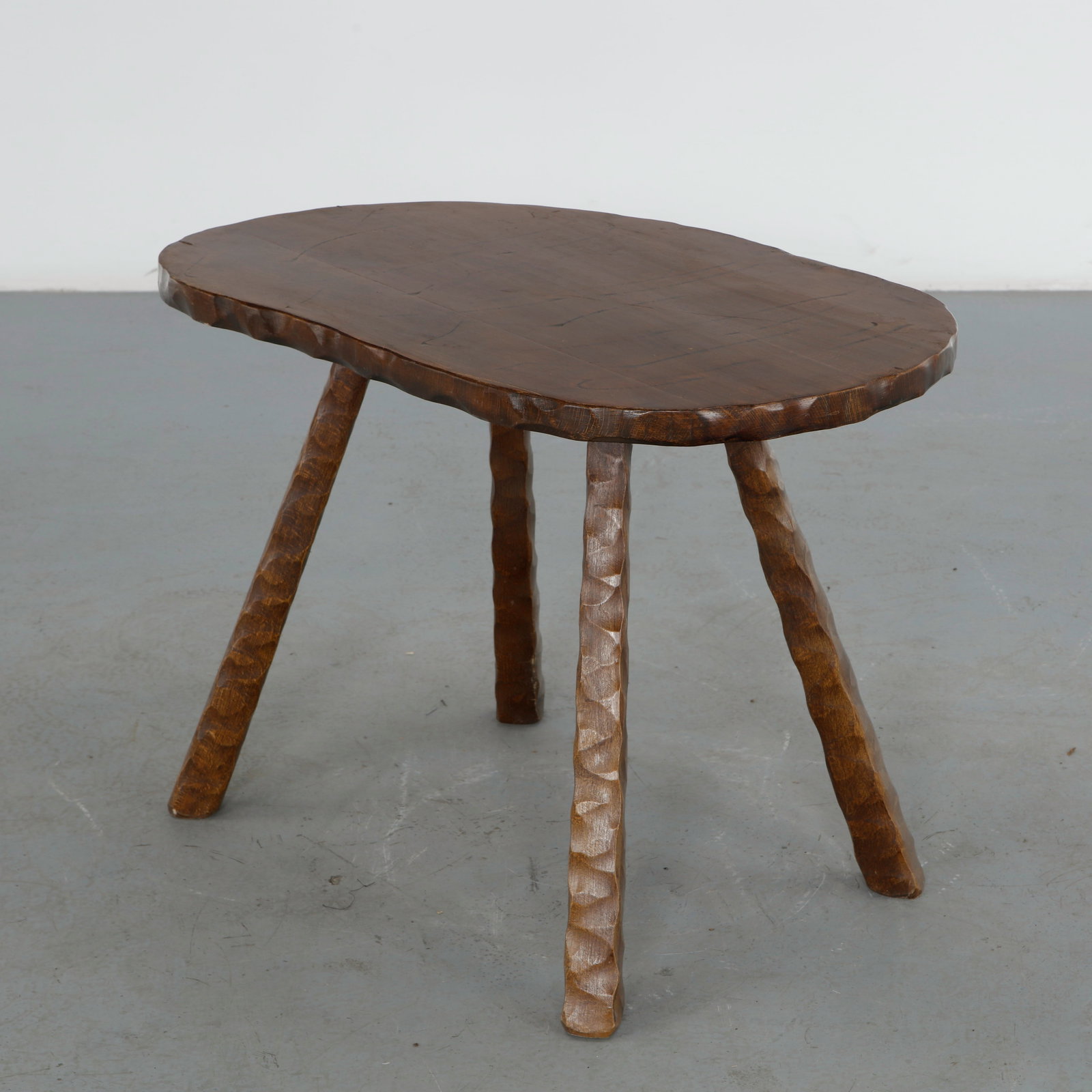 Brutalist Carved Wood Coffee Table, 1960s: Hand carved in solid wood with faceted legs and a thick free form top. The expressive craftsmanship and sculptural silhouette embody the bold aesthetic of the Brutalist movement. Height: 21.5 in. Leng
