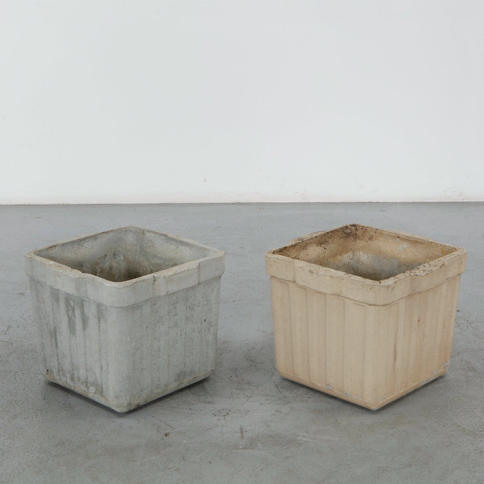 Willy Guhl, Pair of Square Planters, 1960s: A pair of square planters in fiber cement with a vertically ribbed exterior. Weathered grey cream surface. Height: 14.5 in. Length: 17.25 in. Width: 17.25 in.
