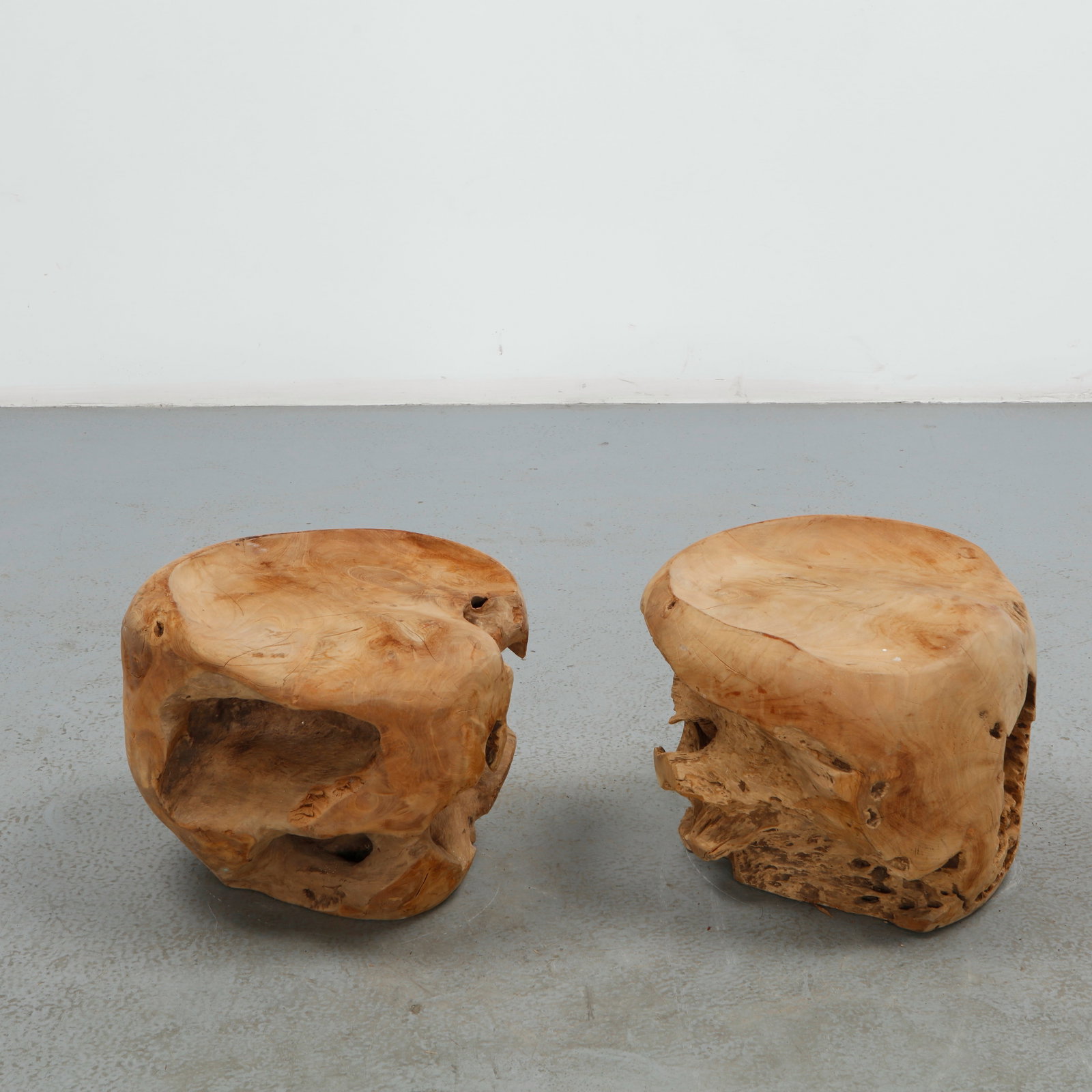 Pair of Handcraved Solid Wood Stools: This pair of stools is carved from solid burl wood, each retaining the organic, hollowed form and rich figuring of the natural trunk. The rugged, sculptural silhouette and warm grain highlight the mat