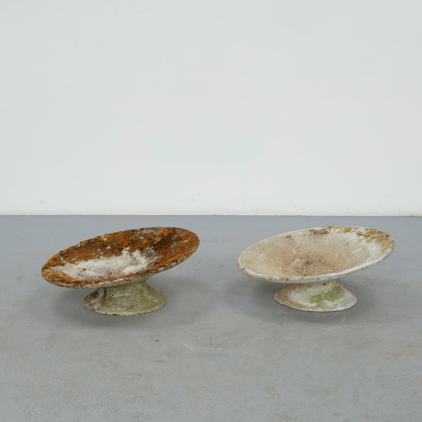 Willy Guhl, Pair of Extra Short Off-Kilter Planters, 1960s: A pair of rare extra small asymmetrical planters by Willy Guhl, featuring a bold modernist design. Diameter: 25 in. Height: 11 in.