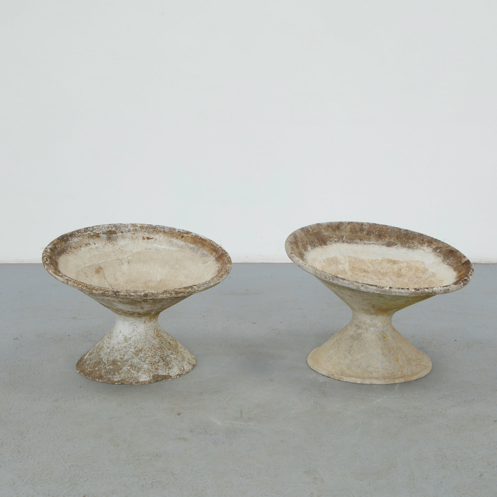 Willy Guhl, Pair of Off-Kilter Planters, 1960s: A pair of rare asymmetrical planters by Willy Guhl, featuring a bold modernist design. TOP Diameter: 25 in. BASE Diameter: 17 in. Height: 18 i