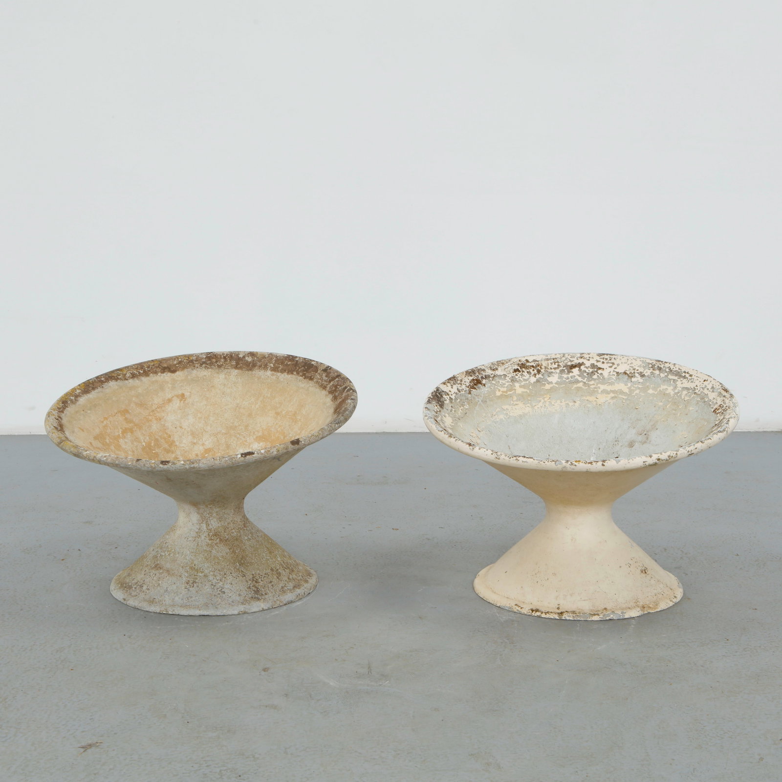 Willy Guhl, Pair of Off-Kilter Planters, 1960s: A pair of rare asymmetrical planters by Willy Guhl, featuring a bold modernist design. TOP Diameter: 25 in. BASE Diameter: 17 in. Height: 18 i