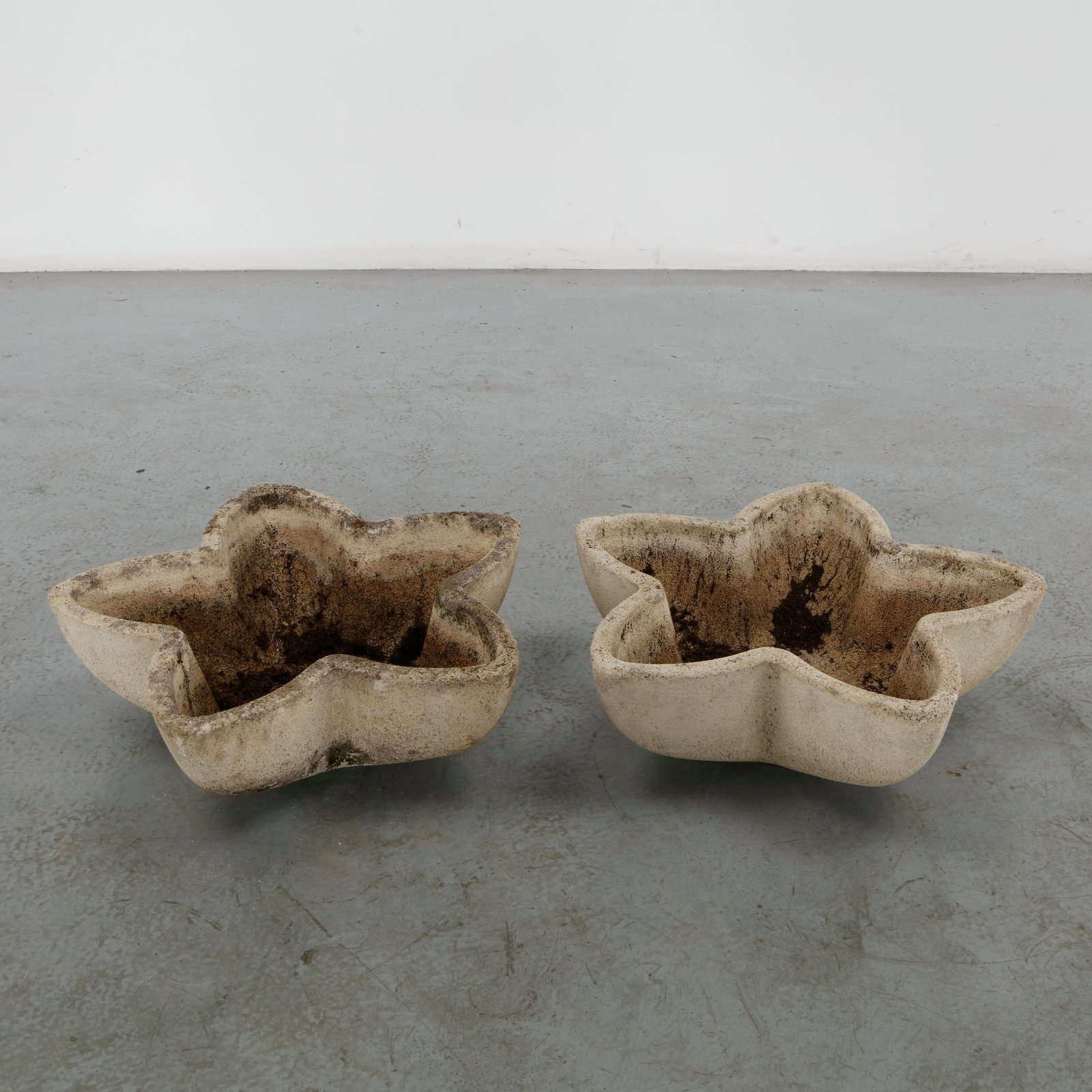 Grandon Fres, Pair of Cast Stone Star Planters, 1960s: A pair of star form planters in cast concrete, their undulating five pointed silhouette a sculptural take on the garden planter form. Weathered cream surface with soil residue to the interior. Height: