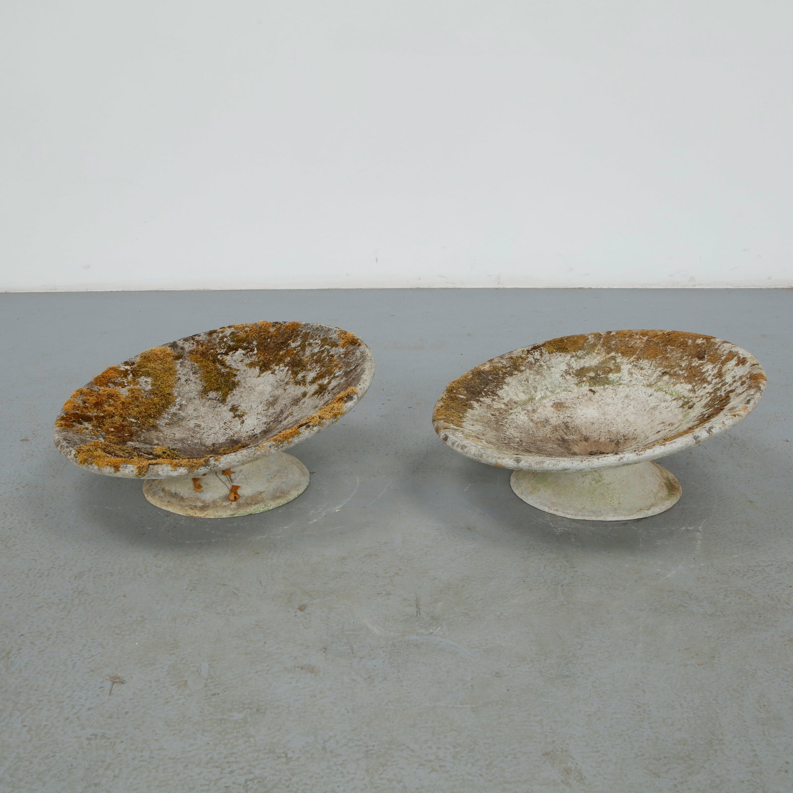 Willy Guhl, Pair of Extra Short Off-Kilter Planters, 1960s: A pair of rare extra small asymmetrical planters by Willy Guhl, featuring a bold modernist design. Diameter: 25 in. Height: 11 in.