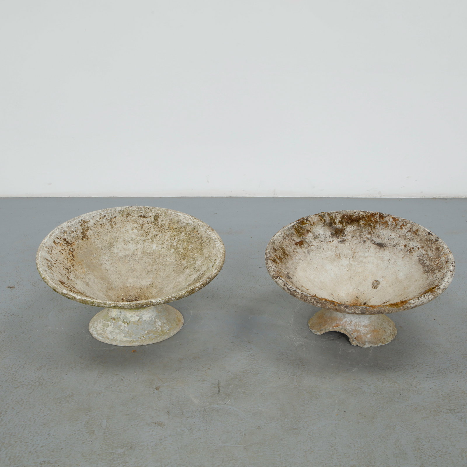 Willy Guhl, Pair of Short Off-Kilter Planters, 1960s: A pair of rare asymmetrical planters by Willy Guhl, featuring a bold modernist design. TOP Diameter: 25 in. BASE Diameter: 13 in. Height: 14.5 in.