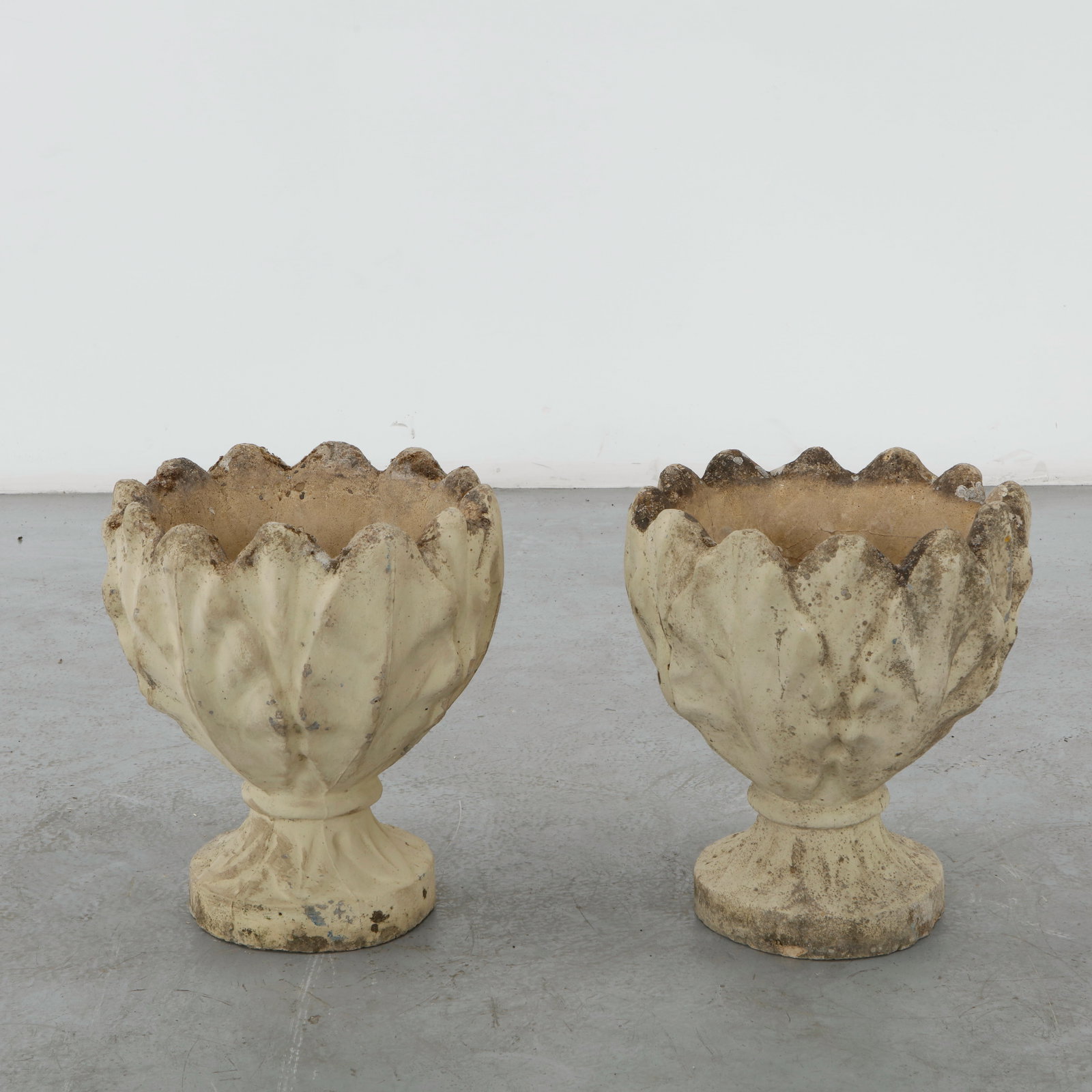 Pair of Lotus Stone Planters, 1960s: Cast stone planters modeled as stylized lotus blossoms with deeply sculpted petals. Their organic form and weathered finish create a sculptural presence in both interior and outdoor settings. Height: