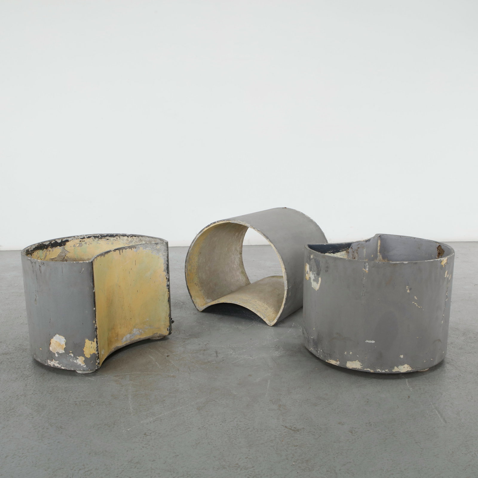 Willy Guhl, Set of Three Large Half Moon Planters, 1960s: A set of three crescent form planters in fiber cement, their open curved silhouettes graduated in size. Weathered painted surface throughout, with paint loss exposing earlier layers. Height: 16 in.