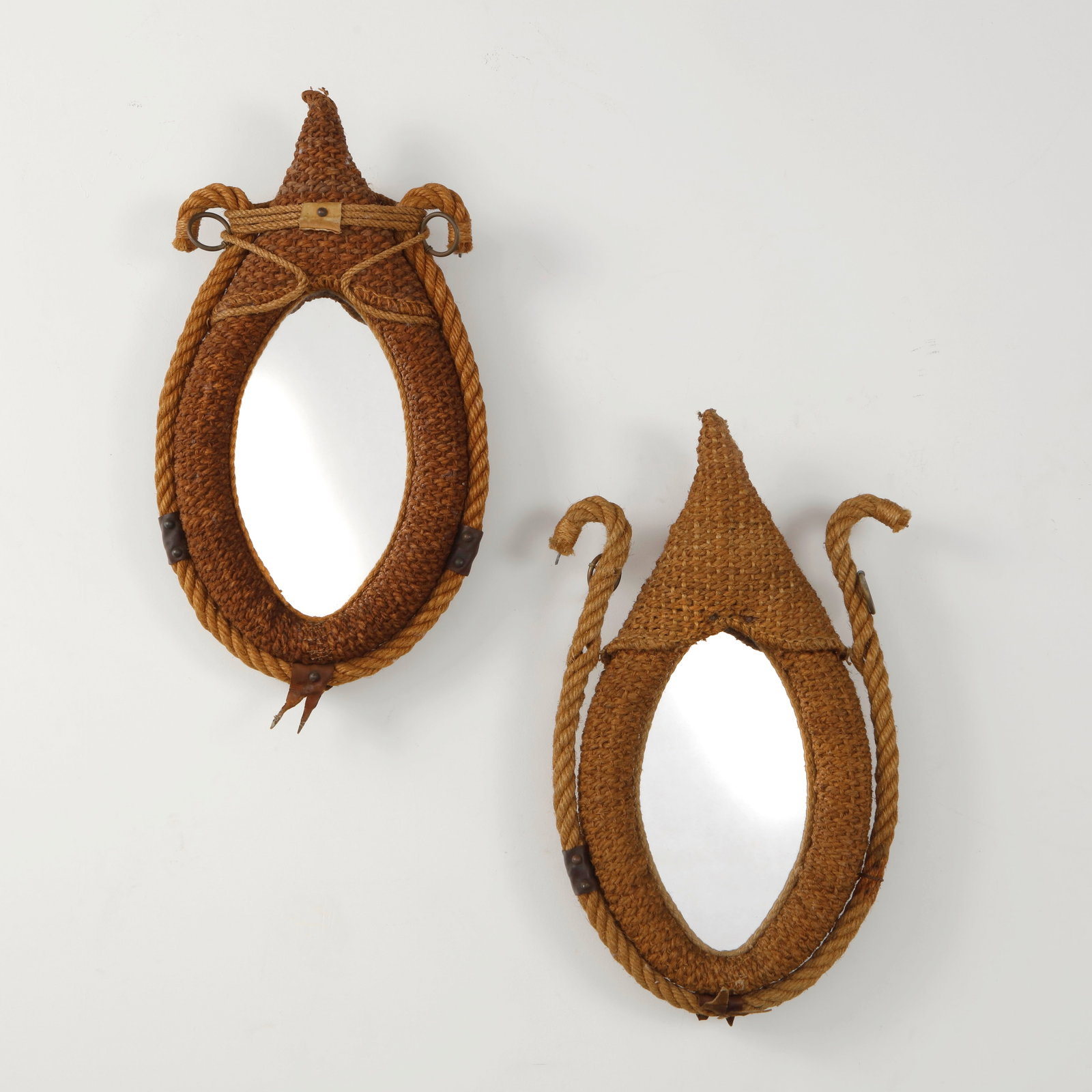 Audoux Minet, Pair of Rope Wall Mirrors, France, 1960s: A rare pair of wall mirrors by Audoux Minet, handwoven in natural rope with sculptural teardrop frames and distinctive nautical detailing. Executed with braided cord, leather accents, and metal fittin
