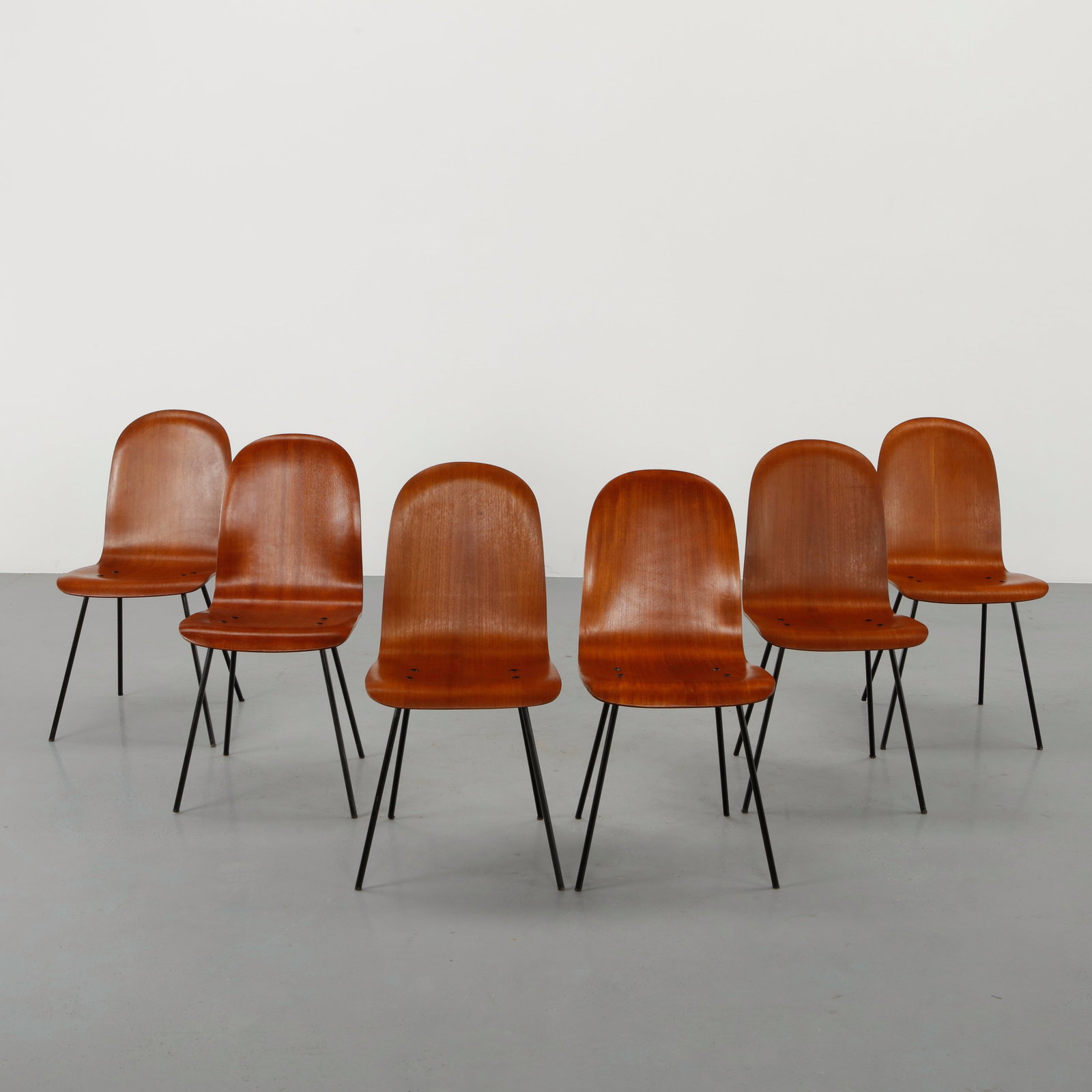 Carlo Ratti, Set of Six Dining Chairs, 1950s: Crafted with curved plywood seats and backs mounted on slender metal legs. The soft organic shell contrasts with the refined linear frame typical of Italian modernism. A balanced and elegant design re