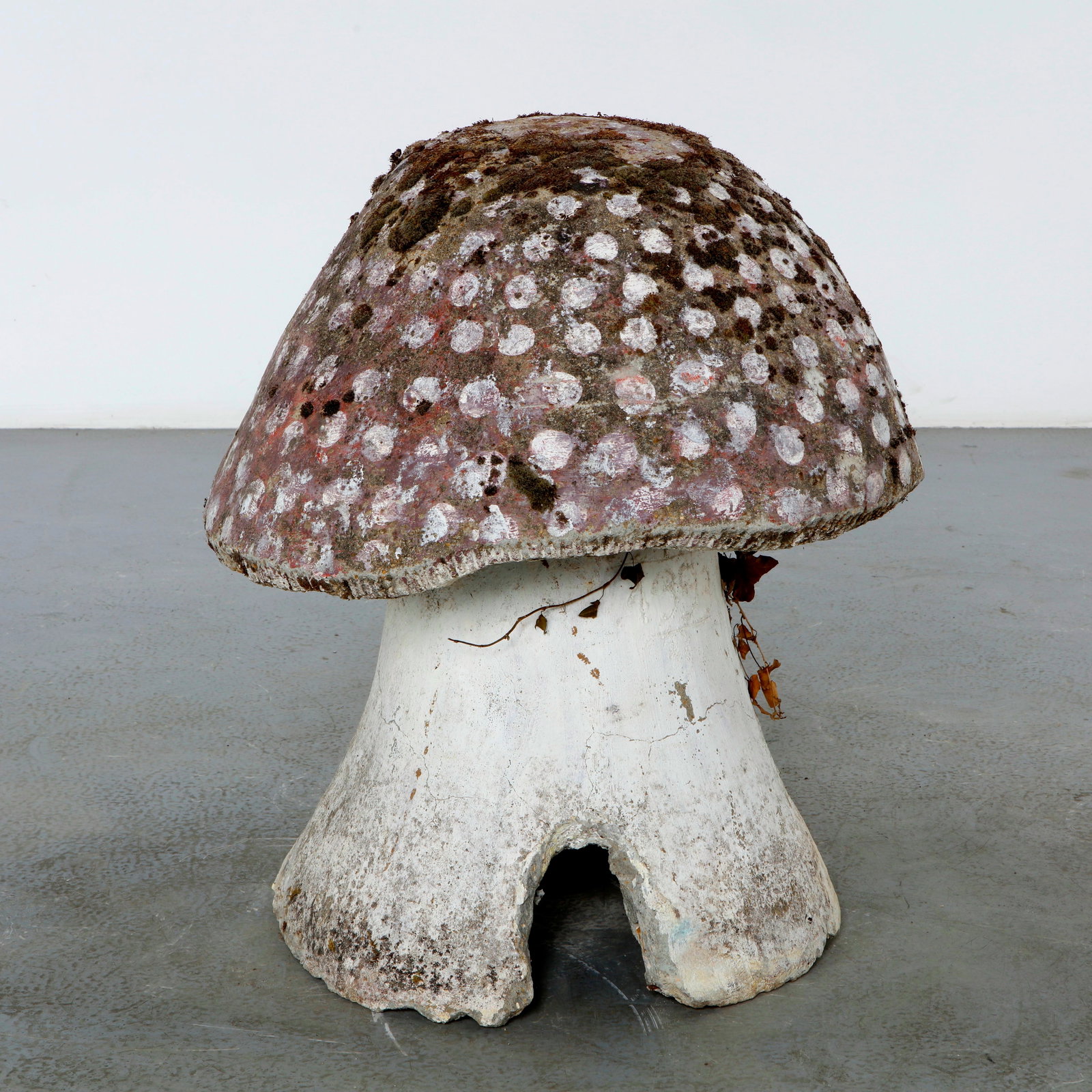 Monumental Mushroom Garden Sculpture, 1960s: A monumental handcrafted garden sculpture in painted concrete, modeled as a whimsical mushroom with a hollow base. Its richly weathered surface, natural moss, and aged polychrome finish create an auth