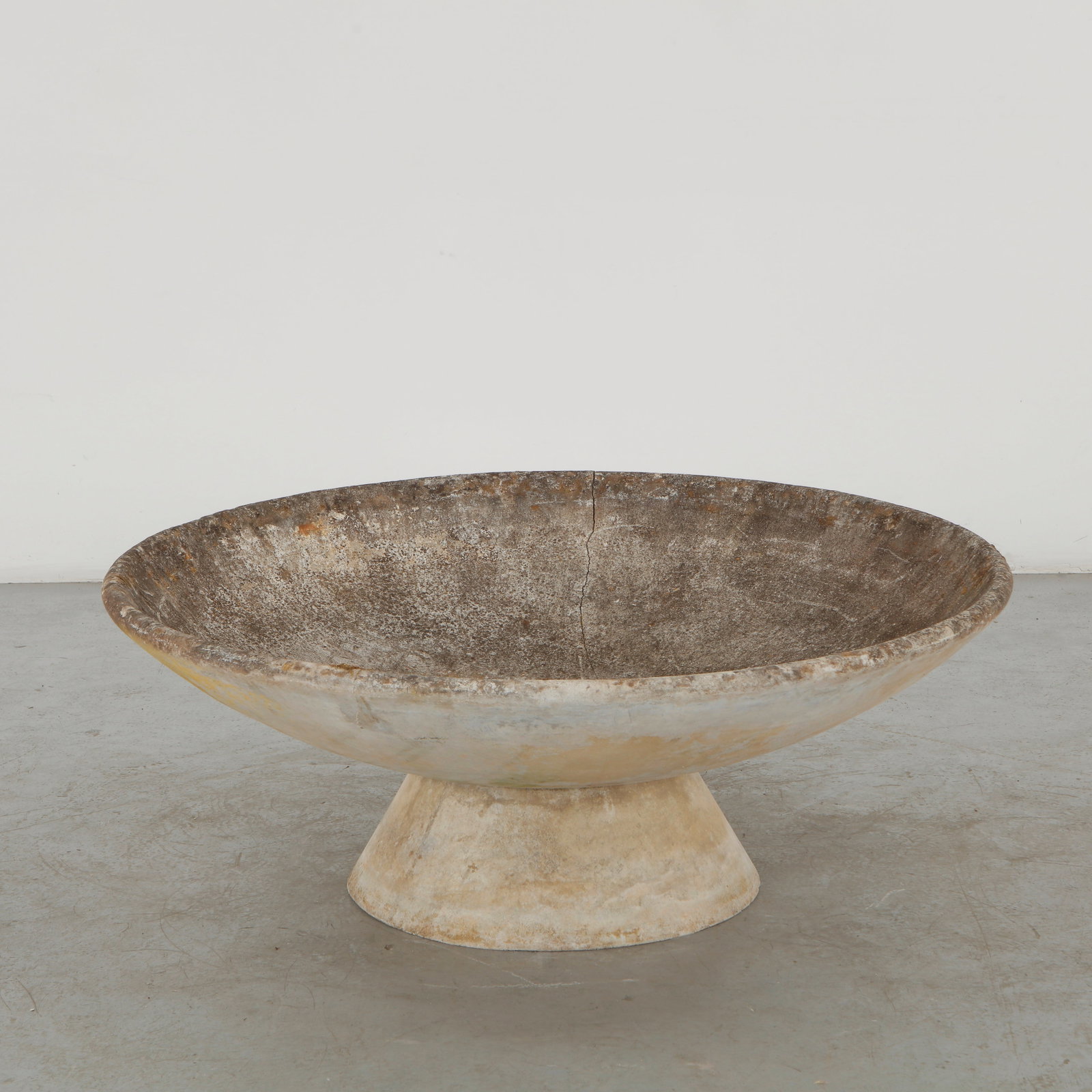 Willy Guhl, Large Bowl Planter with Concrete Stand, 1960s: A monumental bowl planter by Willy Guhl, formed in concrete with a broad, shallow basin resting upon a substantial pedestal base. Its weathered surface and restrained organic geometry exemplify Guhl c