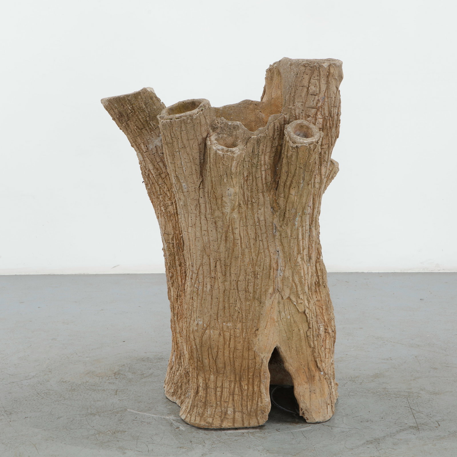 Sculptural Faux Bois Tree Trunk Planter, 1970s: Striking sculptural planter executed in a naturalistic faux bois form, with a richly incised surface imitating the texture of weathered bark. Multiple irregular tubular openings rise organically from 