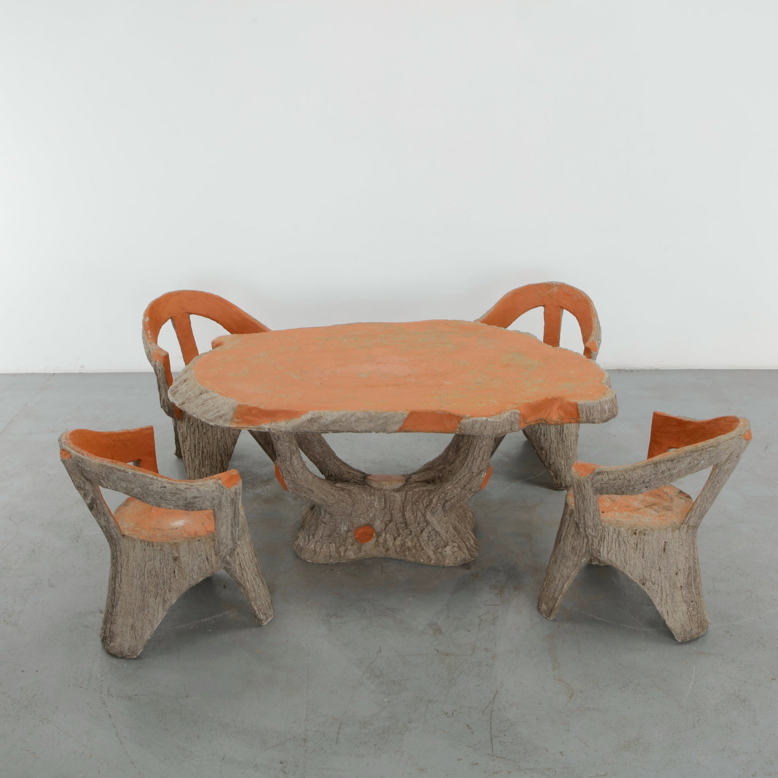 Faux Bois Outdoor Dining Set, 1960s: A distinctive faux bois outdoor dining set comprising a sculptural table and four matching armchairs, all executed in textured concrete imitating natural wood. The expressive irregularity of the surfa