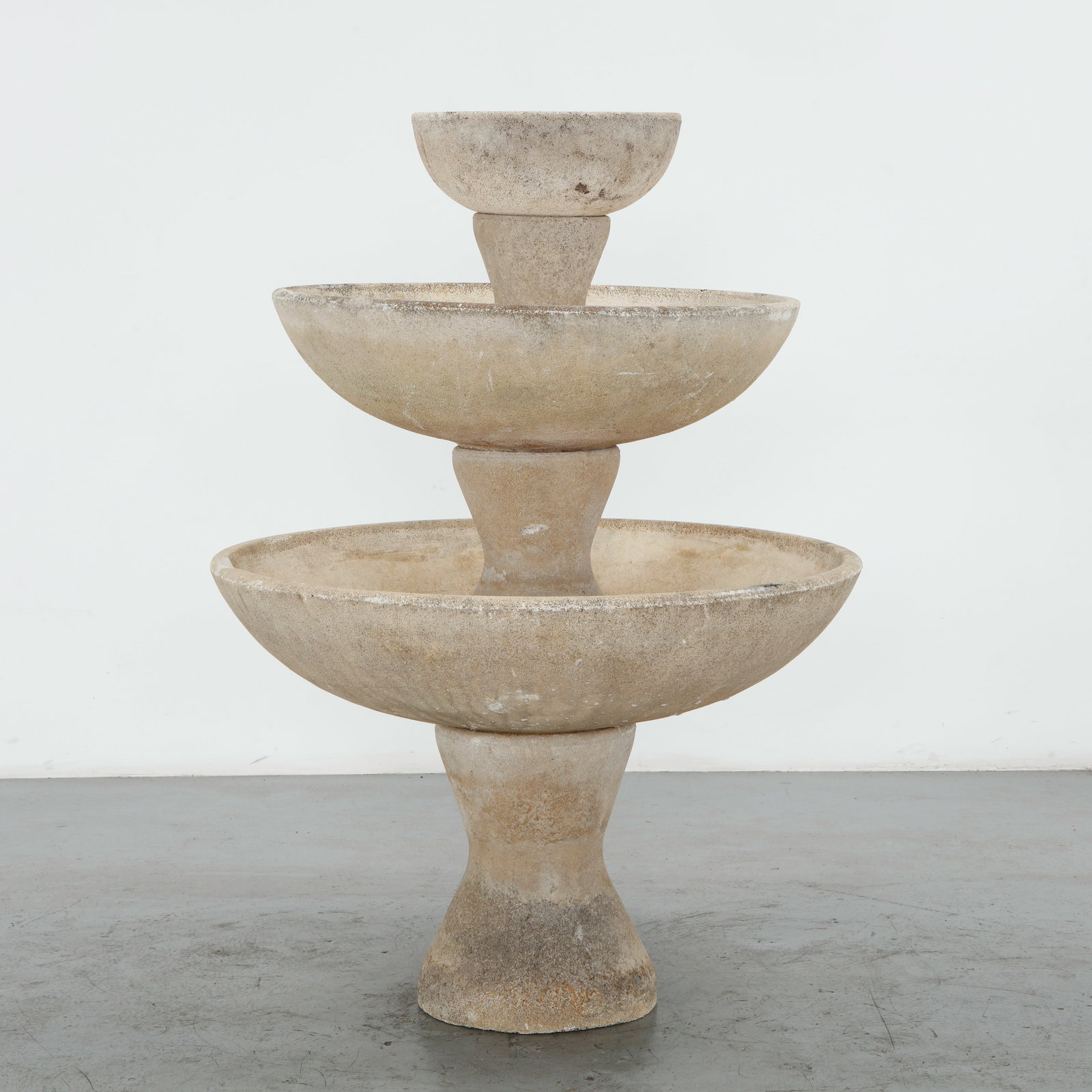 Monumental Cast Stone Fountain, 1960s: Monumental cast stone fountain composed of tiered basins with a richly weathered surface and sculptural, architectural presence. The uppermost bowl is without a drainage hole, unlike the lower basins,