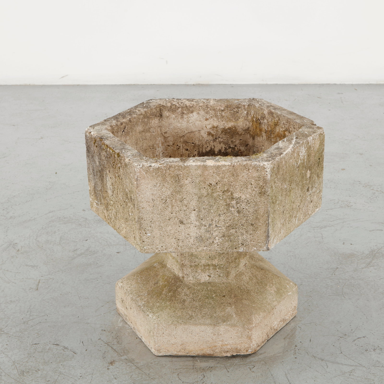 Brutalist Stone Fountain, 1970s: Sculptural Brutalist fountain executed in stone, featuring a substantial octagonal basin raised on a faceted pedestal and broad geometric plinth. The central metal water inlet remains visible within t