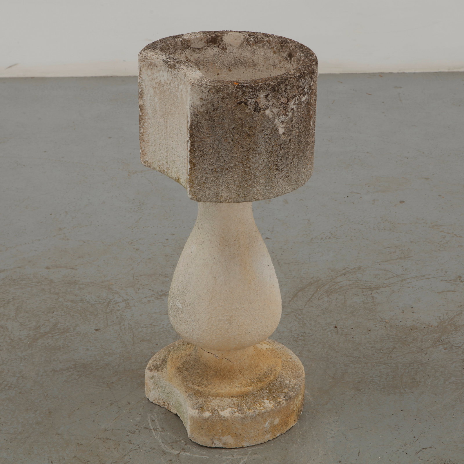 Limestone Half Moon Planter, 1960s: Sculpted in weathered limestone, this substantial garden planter features a softly rounded, asymmetrical form elevated on a sculptural pedestal. The naturally aged surface, marked by mineral patinatio