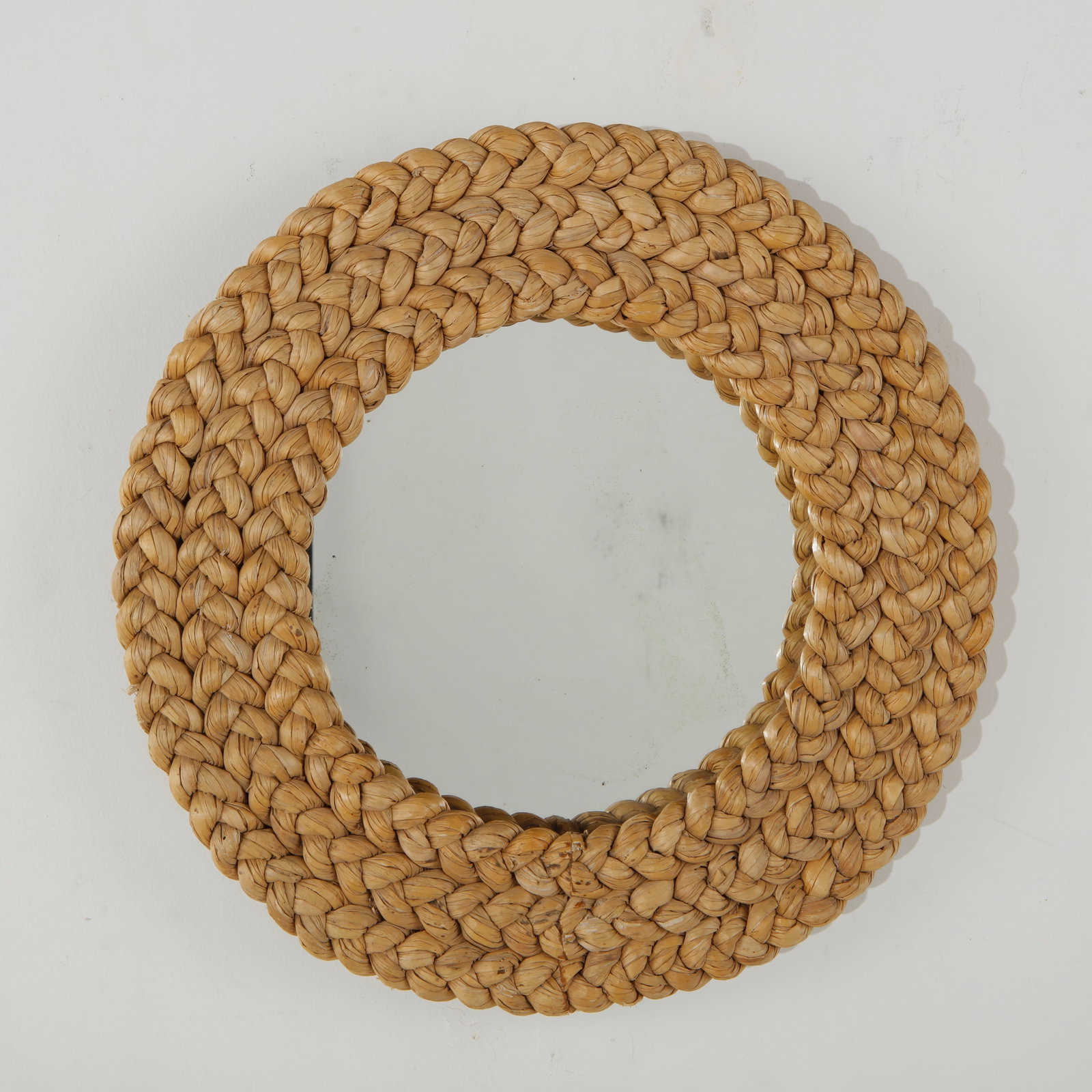 Audoux Minet, Round Rope Miror, 1960s: A sculptural circular mirror surrounded by a substantial frame of natural rope, meticulously braided into a tactile, repeating pattern. The use of organic materials and pronounced artisanal craftsmans