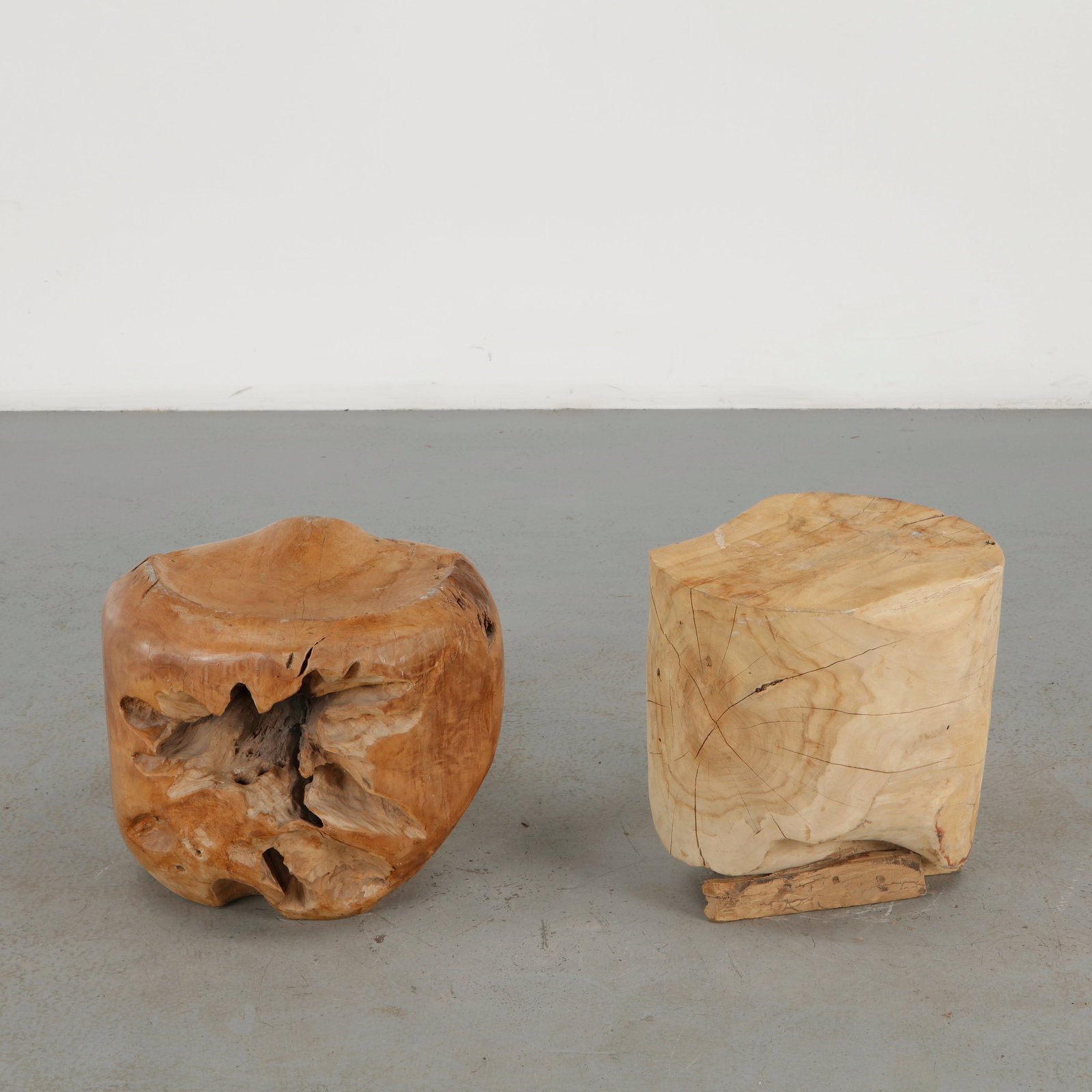 Pair of Handcarved Solid Wood Stools: This pair of stools is carved from solid burl wood, each retaining the organic, hollowed form and rich figuring of the natural trunk. The rugged, sculptural silhouette and warm grain highlight the