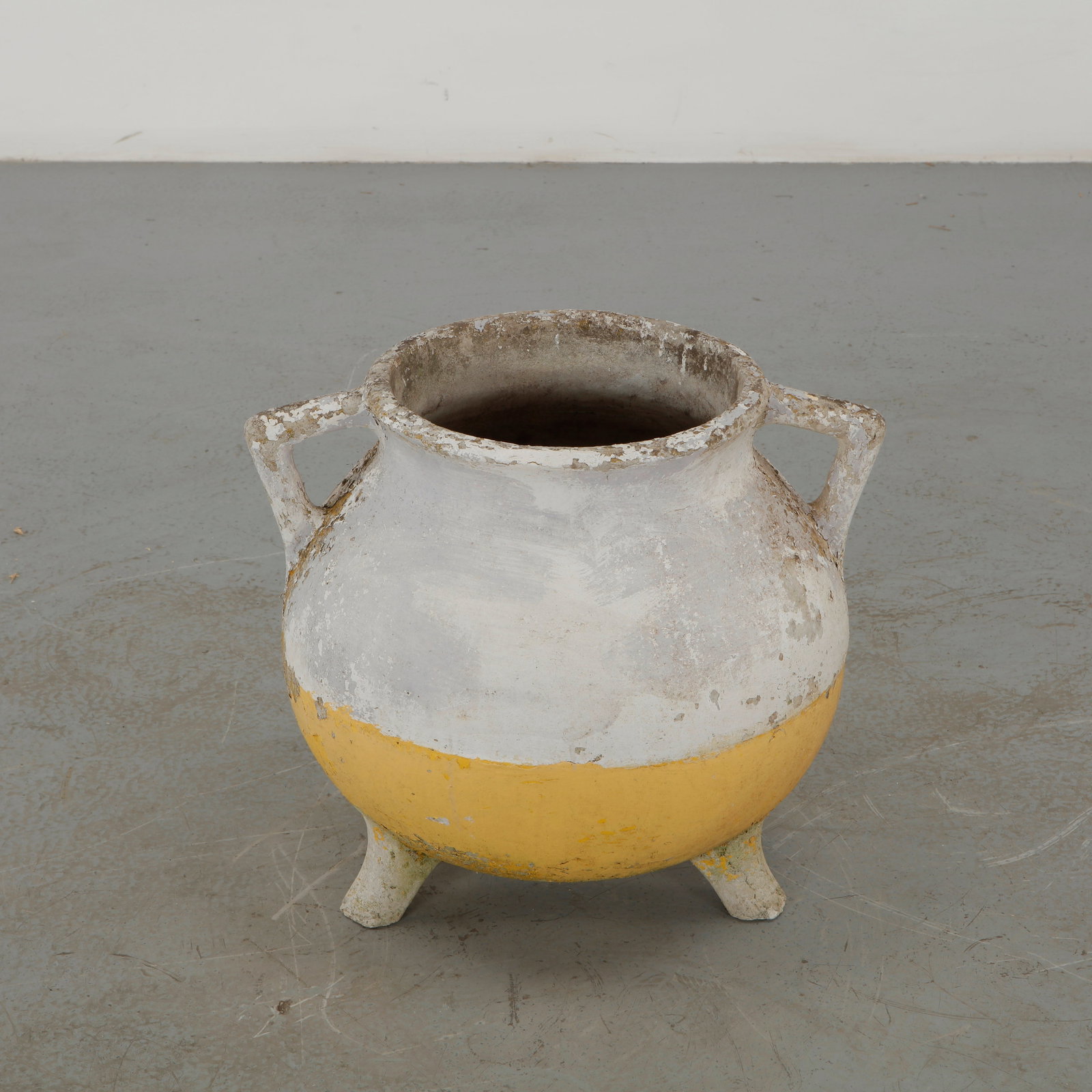 Willy Guhl, Cauldron Planter, 1960s: Executed in fiber cement, this cauldron form planter features two loop handles and raised tripod feet beneath a green painted finish. Losses to the surface reveal the pale material beneath, adding