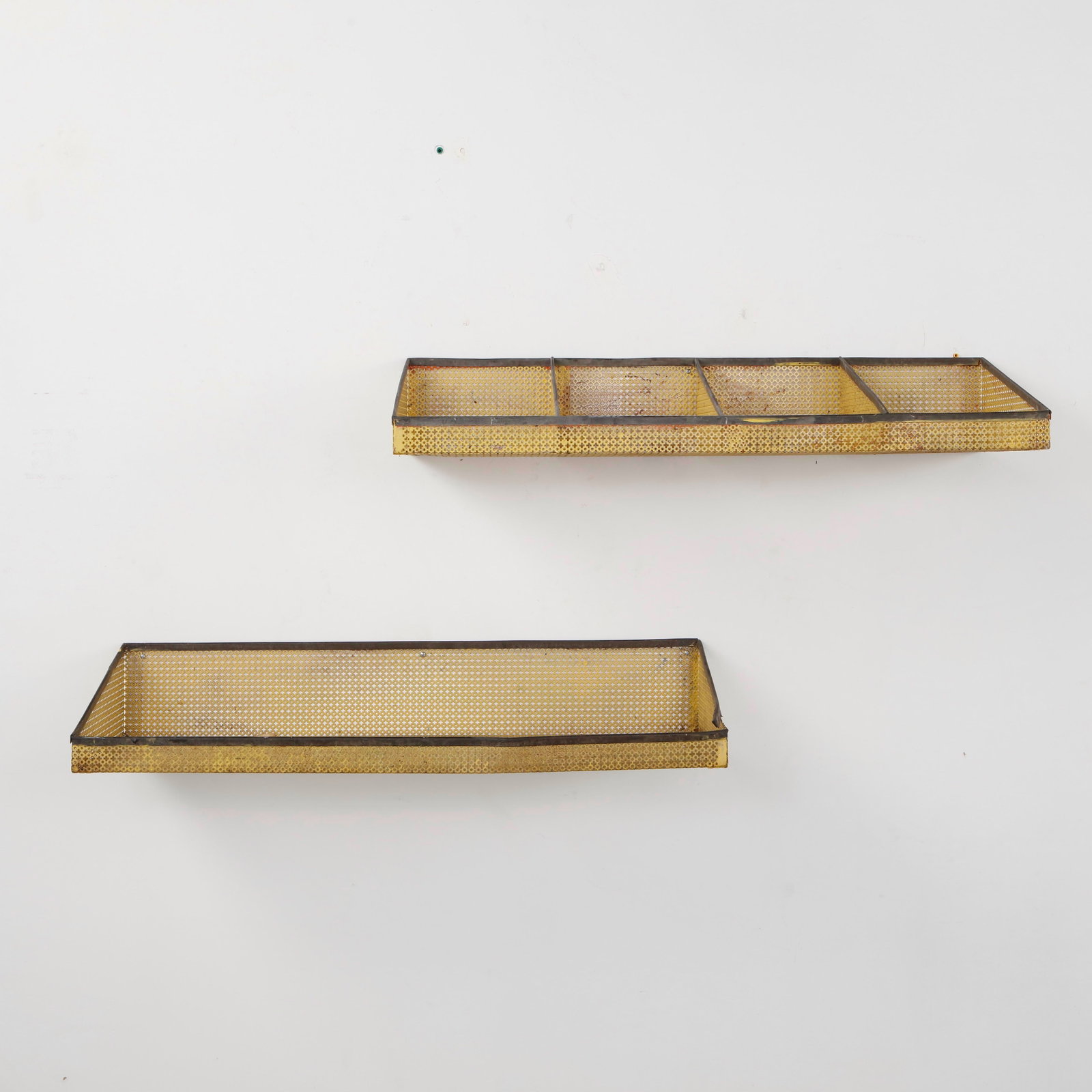 Mathieu Mategot, Pair of Perforated Metal Wall Shelves in Yellow, 1950s: A rare pair of wall mounted shelves by Mathieu Mategot, executed in perforated sheet metal with a distinctive yellow painted finish. The geometric construction and perforated surface exemplify