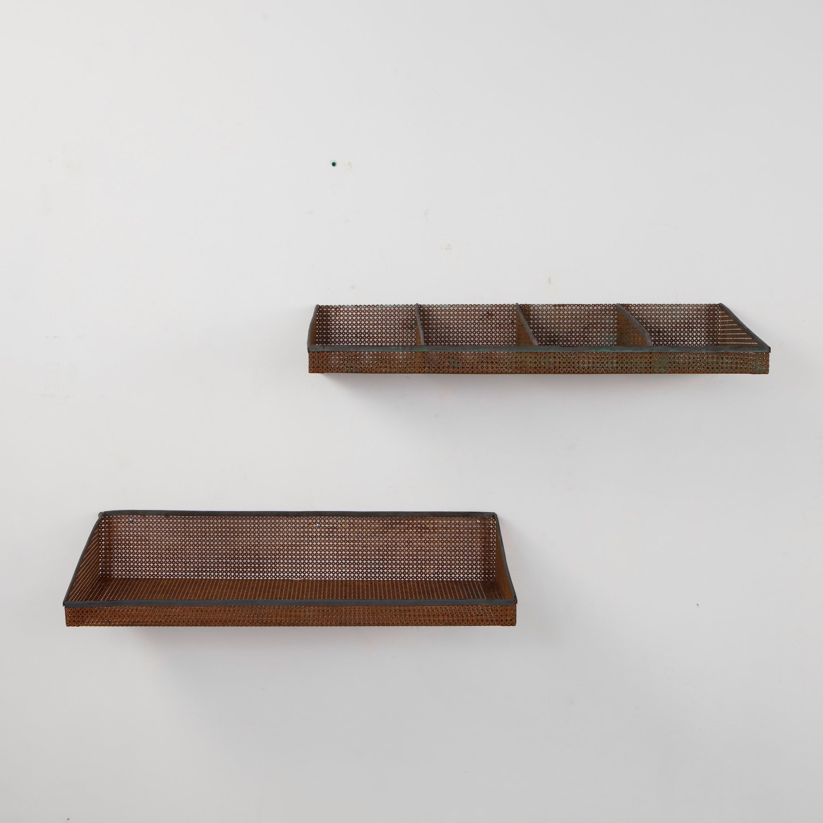 Mathieu Mategot, Pair of Perforated Metal Wall Shelves, 1950s: A distinctive pair of wall mounted shelves by Mathieu Mategot, formed from finely perforated metal and articulated with internal divisions. The rhythmic mesh surface and restrained linear structure