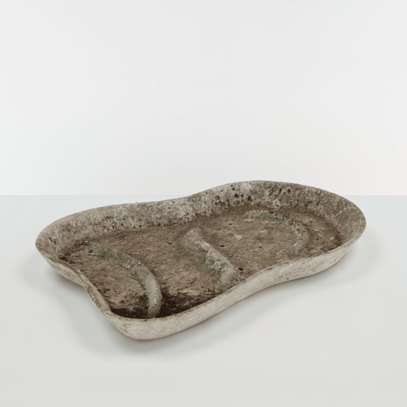Willy Guhl, Bird Bath Planter, 1960s: Sculptural concrete planter of organically irregular form, with a broad shallow basin and softly undulating rim. The weathered surface bears an expressive patina developed through outdoor exposure,