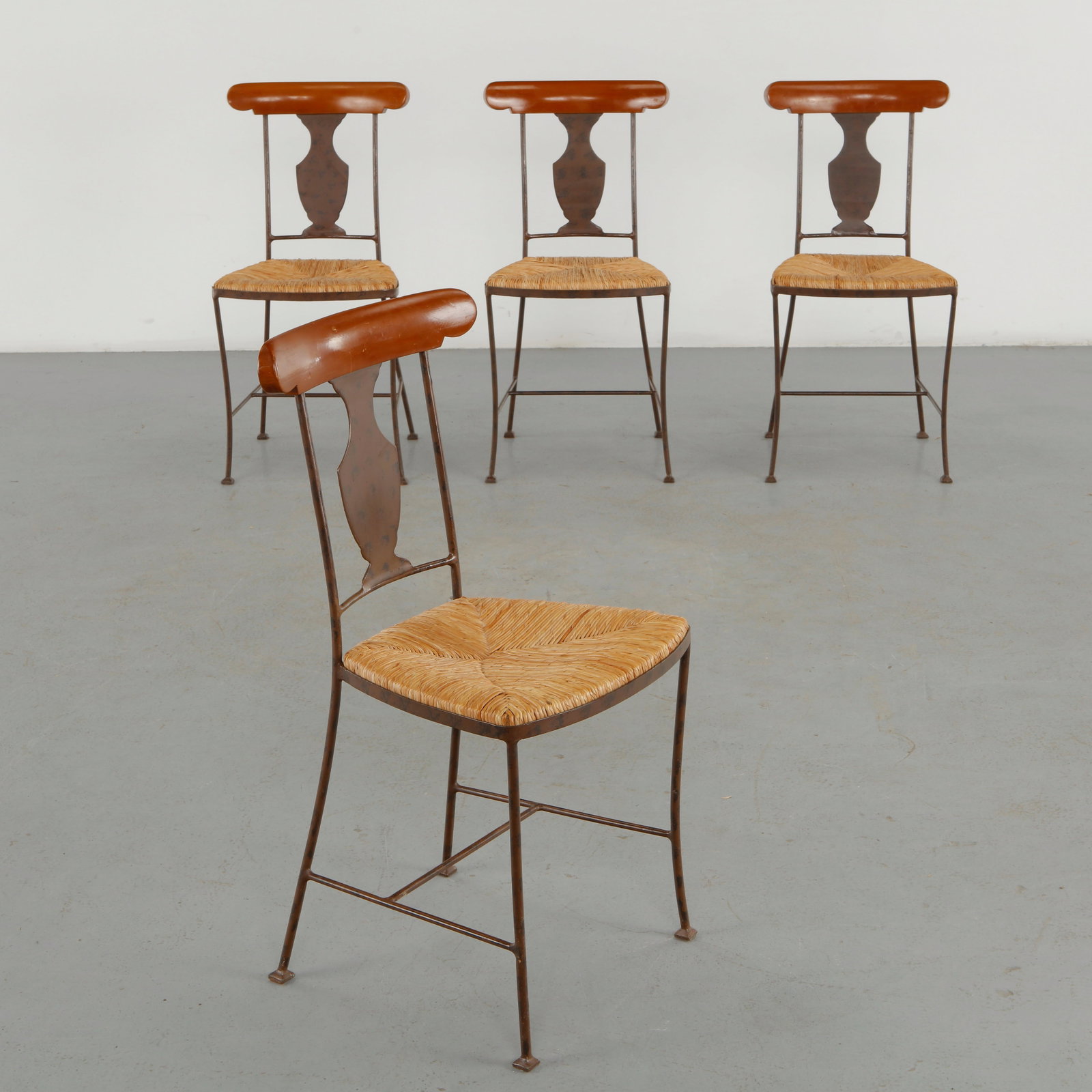 Set of Four Rope and Metal Dining Chairs, 1960s: A set of four distinctive dining chairs combining slender metal frames with sculpted wooden crest rails and hand woven rope seats. The juxtaposition of industrial metal, warm timber and natural fiber 