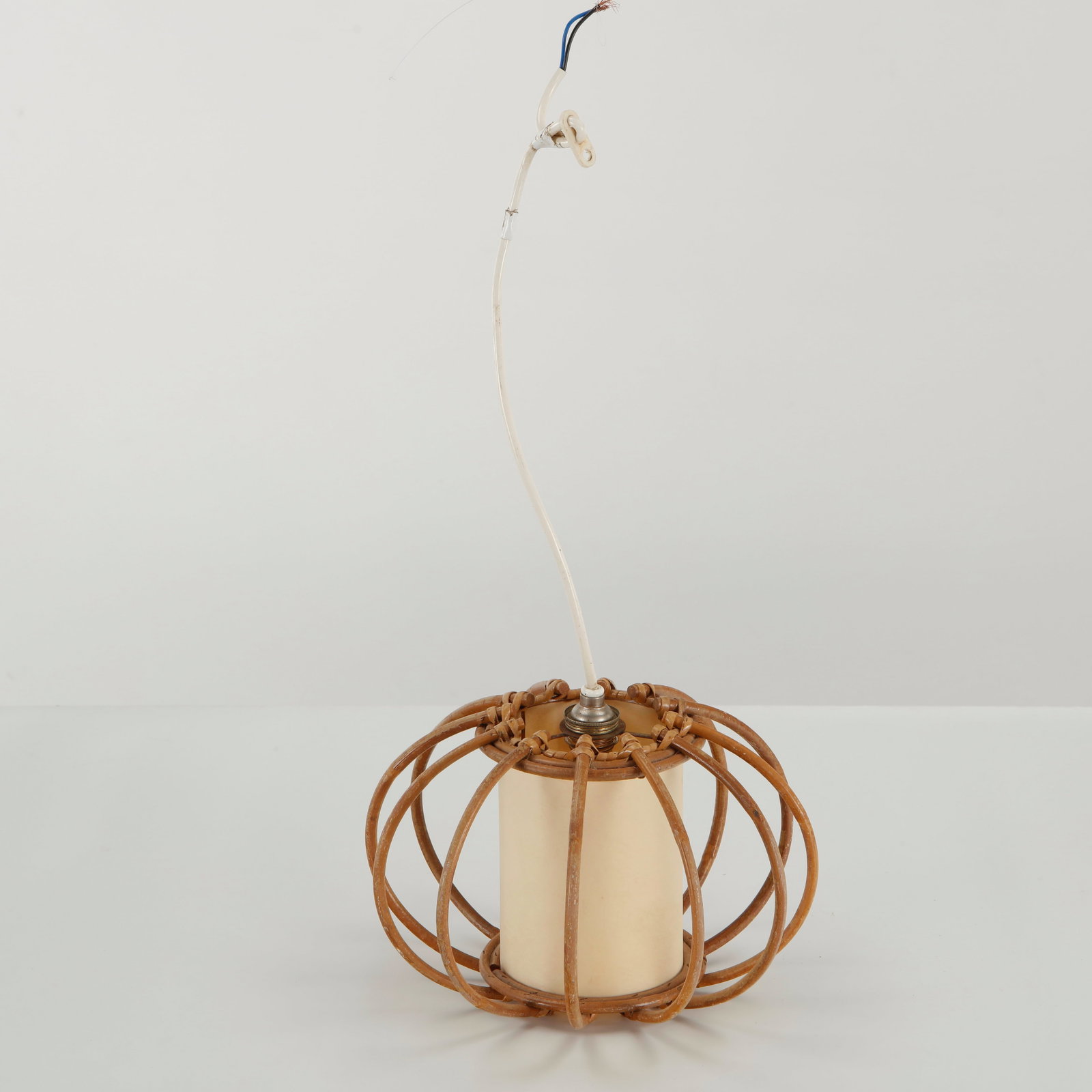 Louis Sognot, Rattan Loop Pendant Lamp, 1960s: A sculptural pendant light in natural rattan, distinguished by elongated looping elements surrounding a softly diffusing textile shade. The repeated curves create an elegant open framework while empha
