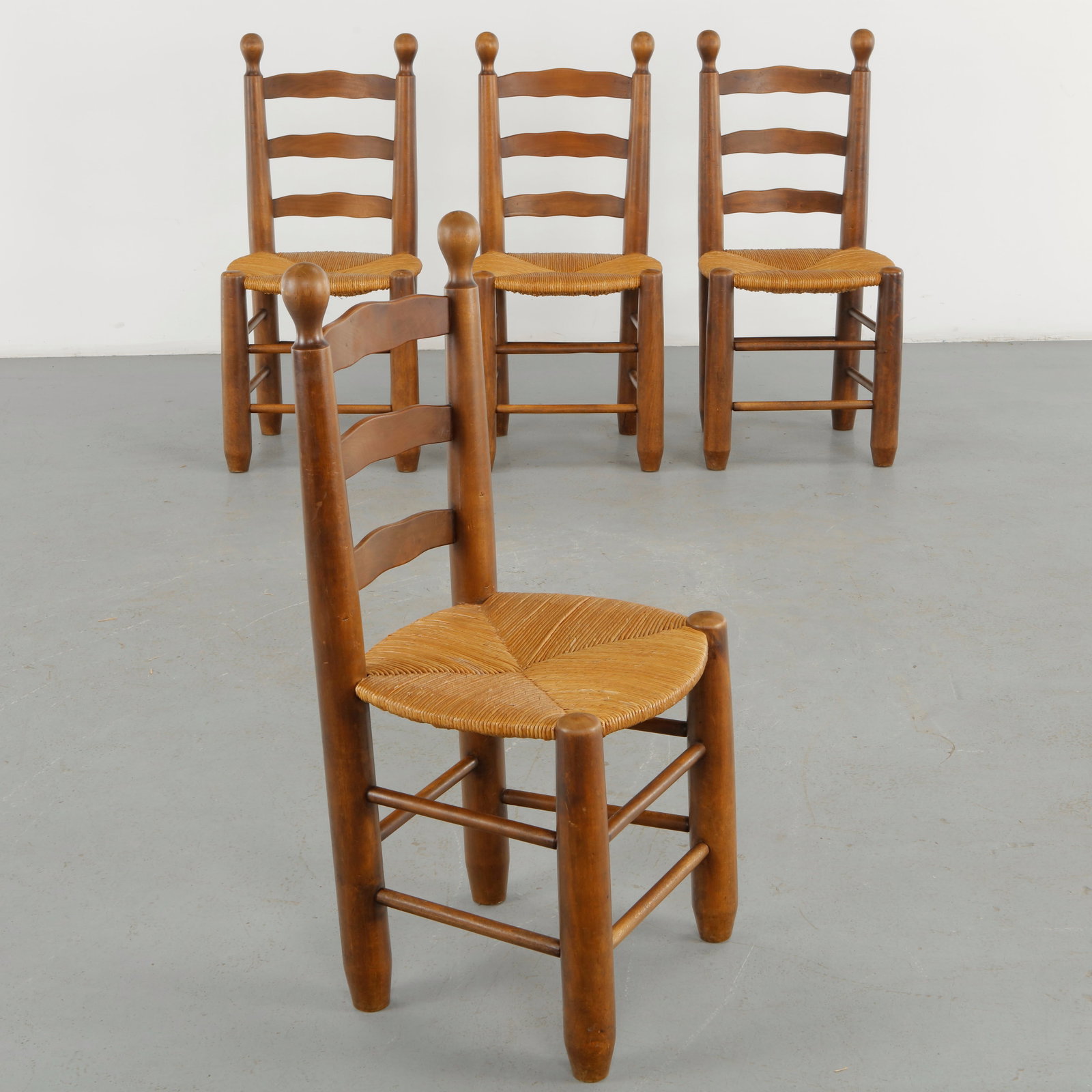 Charles Dudouyt, Set of Four Rope and Wood Chairs, 1960s: A set of four chairs by Charles Dudouyt, executed in richly patinated wood with woven rope seats and elongated open backs. The substantial turned legs and restrained construction emphasize the robust 